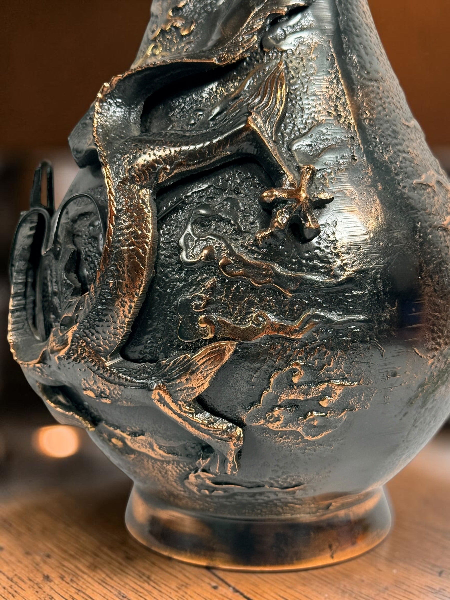Japanese Meiji-style dragon vase in cast metal with dark bronze finish. Features high-relief dragon decoration, textured surface, and stands 12 inches tall.