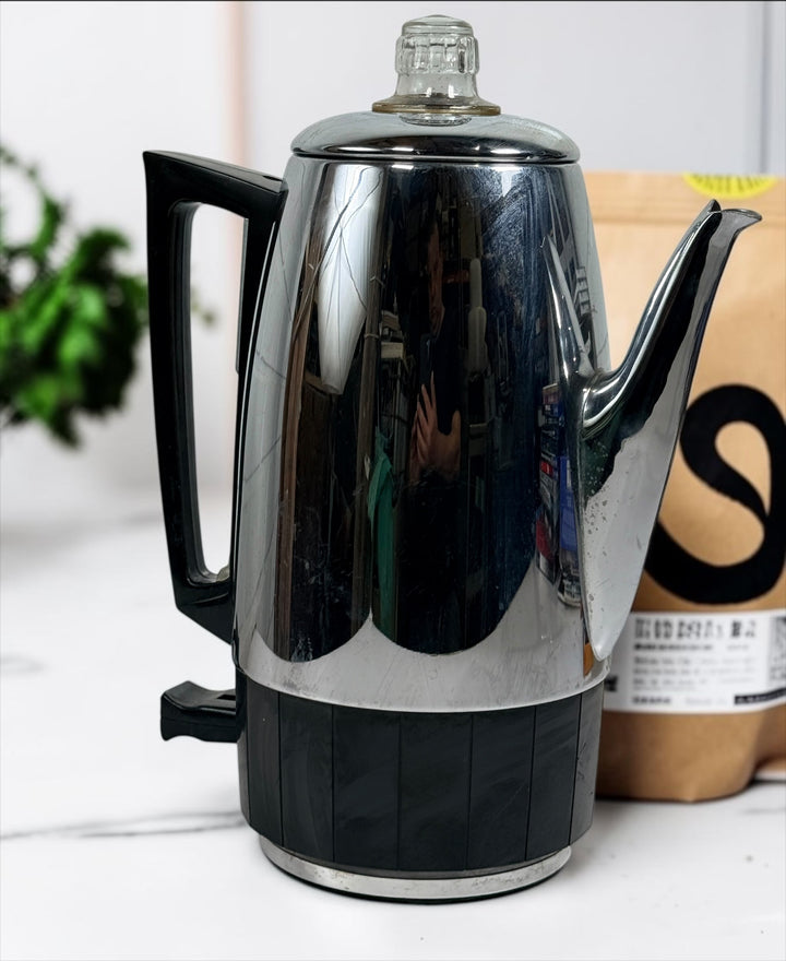 Vintage Sunbeam Coffeemaster Deluxe AP18 9-cup electric percolator made in Canada, featuring adjustable brew strength, a coffee-level gauge, and classic mid-century chrome styling.