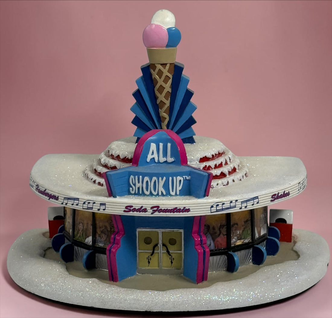 Official 2005 Hawthorne Village “All Shook Up” Soda Fountain from the Elvis Presley Rock ‘n’ Roll Holiday Village collection, featuring colorful retro diner details and snowy accents.
