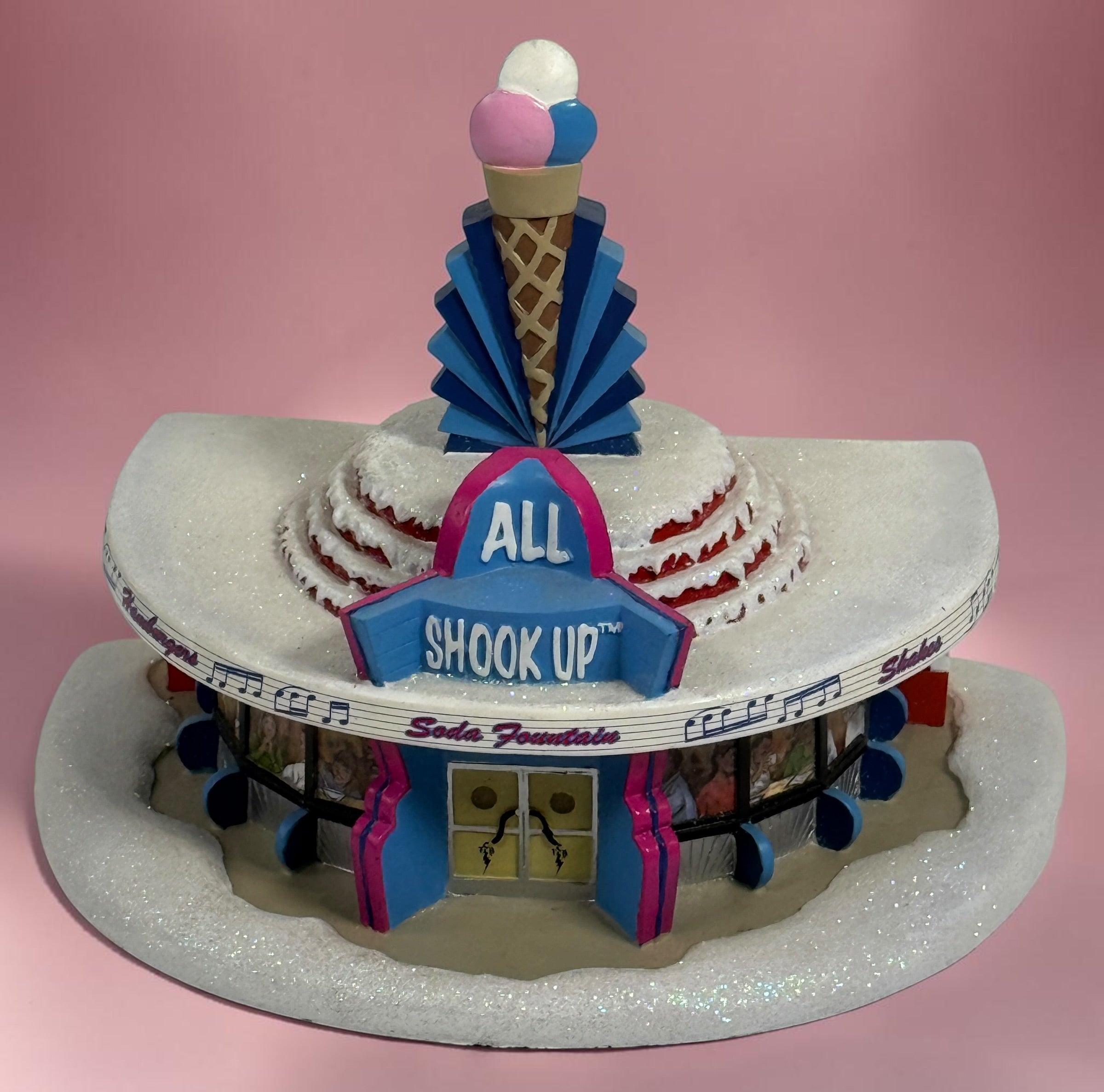 Official 2005 Hawthorne Village “All Shook Up” Soda Fountain from the Elvis Presley Rock ‘n’ Roll Holiday Village collection, featuring colorful retro diner details and snowy accents.
