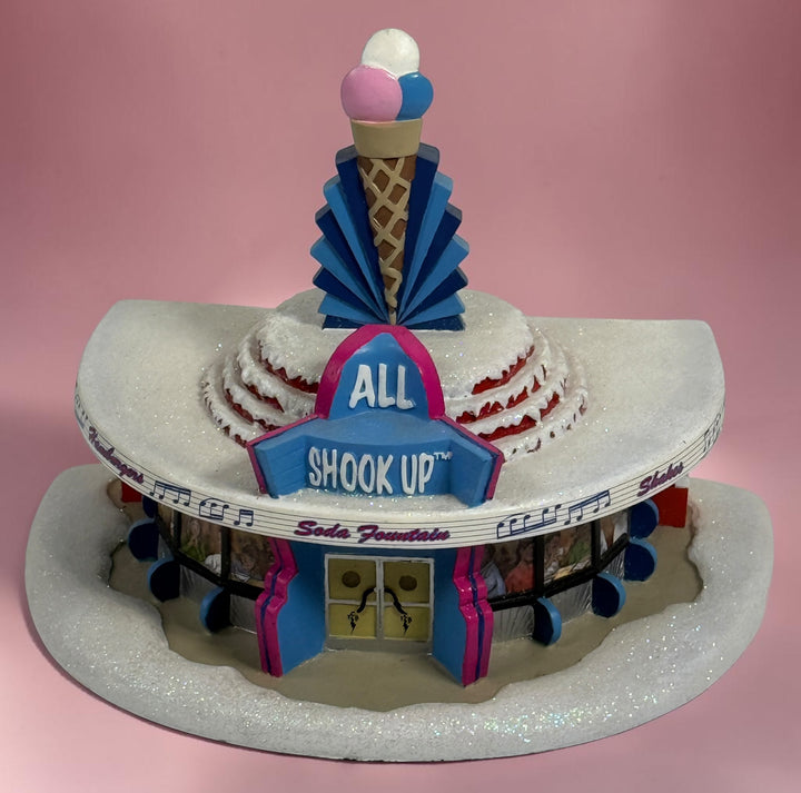 Official 2005 Hawthorne Village “All Shook Up” Soda Fountain from the Elvis Presley Rock ‘n’ Roll Holiday Village collection, featuring colorful retro diner details and snowy accents.