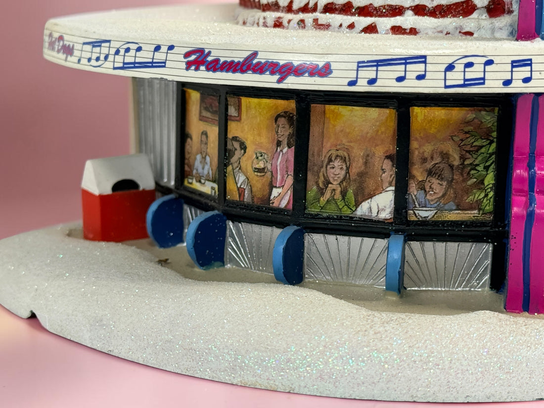 Official 2005 Hawthorne Village “All Shook Up” Soda Fountain from the Elvis Presley Rock ‘n’ Roll Holiday Village collection, featuring colorful retro diner details and snowy accents.