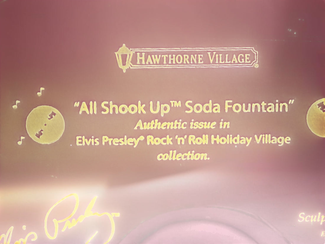Official 2005 Hawthorne Village “All Shook Up” Soda Fountain from the Elvis Presley Rock ‘n’ Roll Holiday Village collection, featuring colorful retro diner details and snowy accents.
