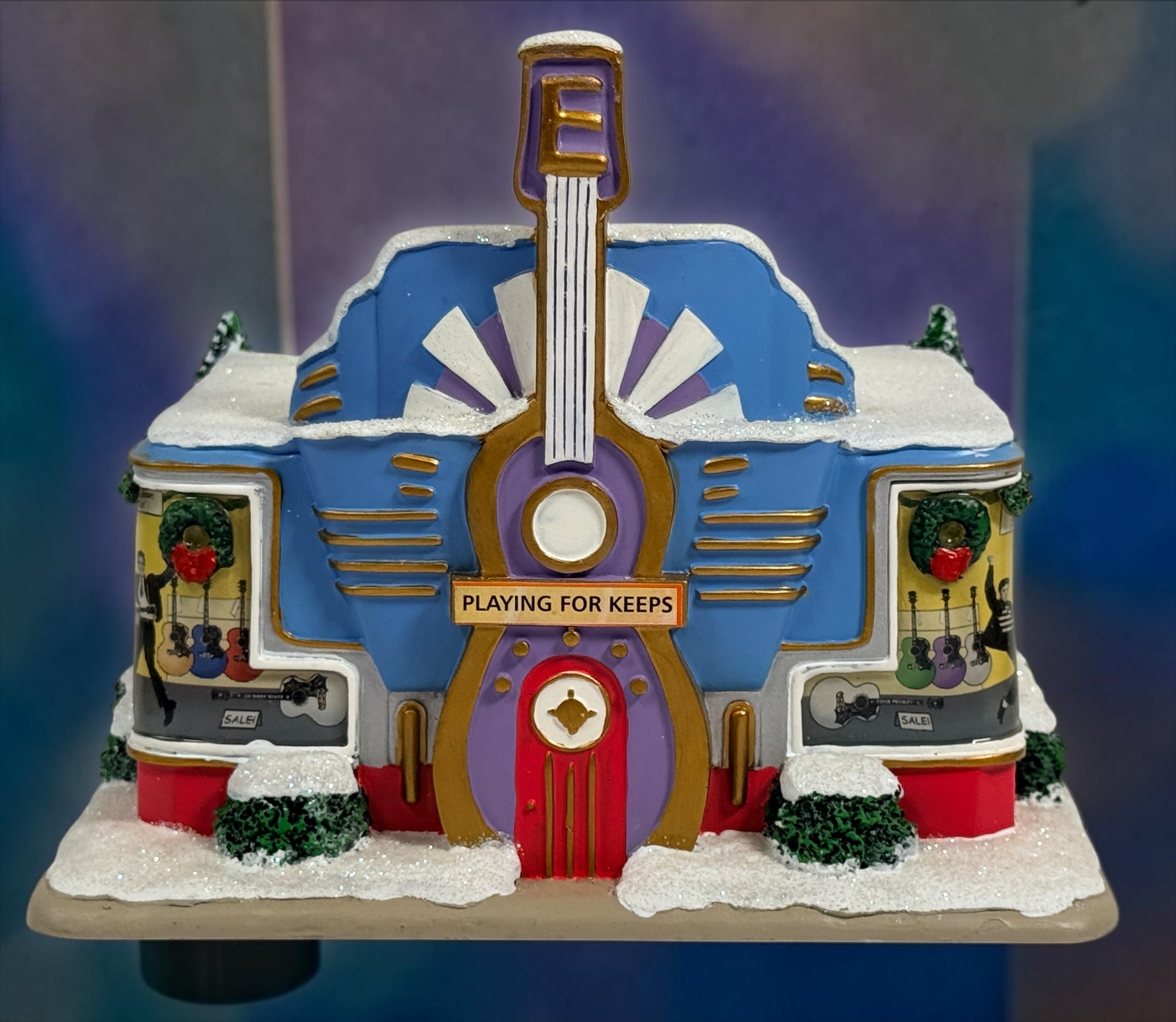 Official Hawthorne Village “Playing for Keeps” Guitar Store from the 2007 Elvis Presley Rock ‘n’ Roll Holiday Village collection featuring festive details and retro styling.