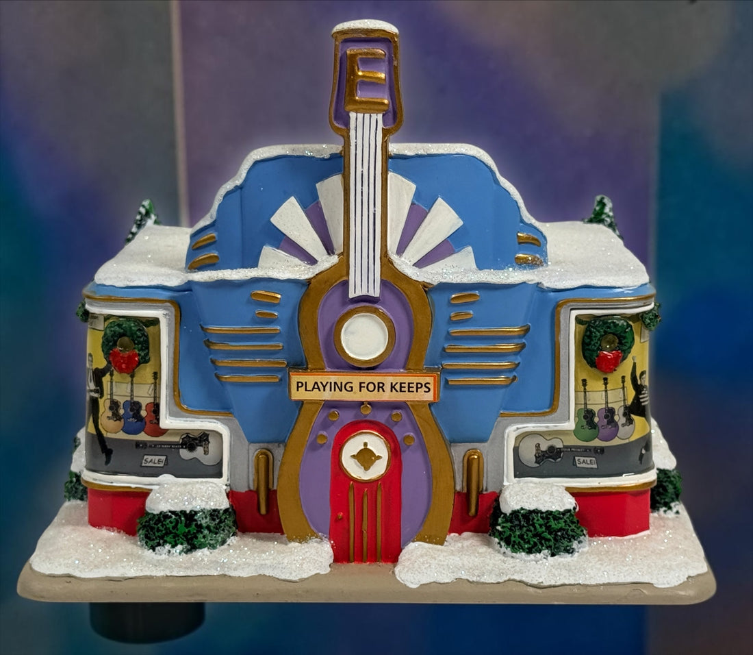 Official Hawthorne Village “Playing for Keeps” Guitar Store from the 2007 Elvis Presley Rock ‘n’ Roll Holiday Village collection featuring festive details and retro styling.