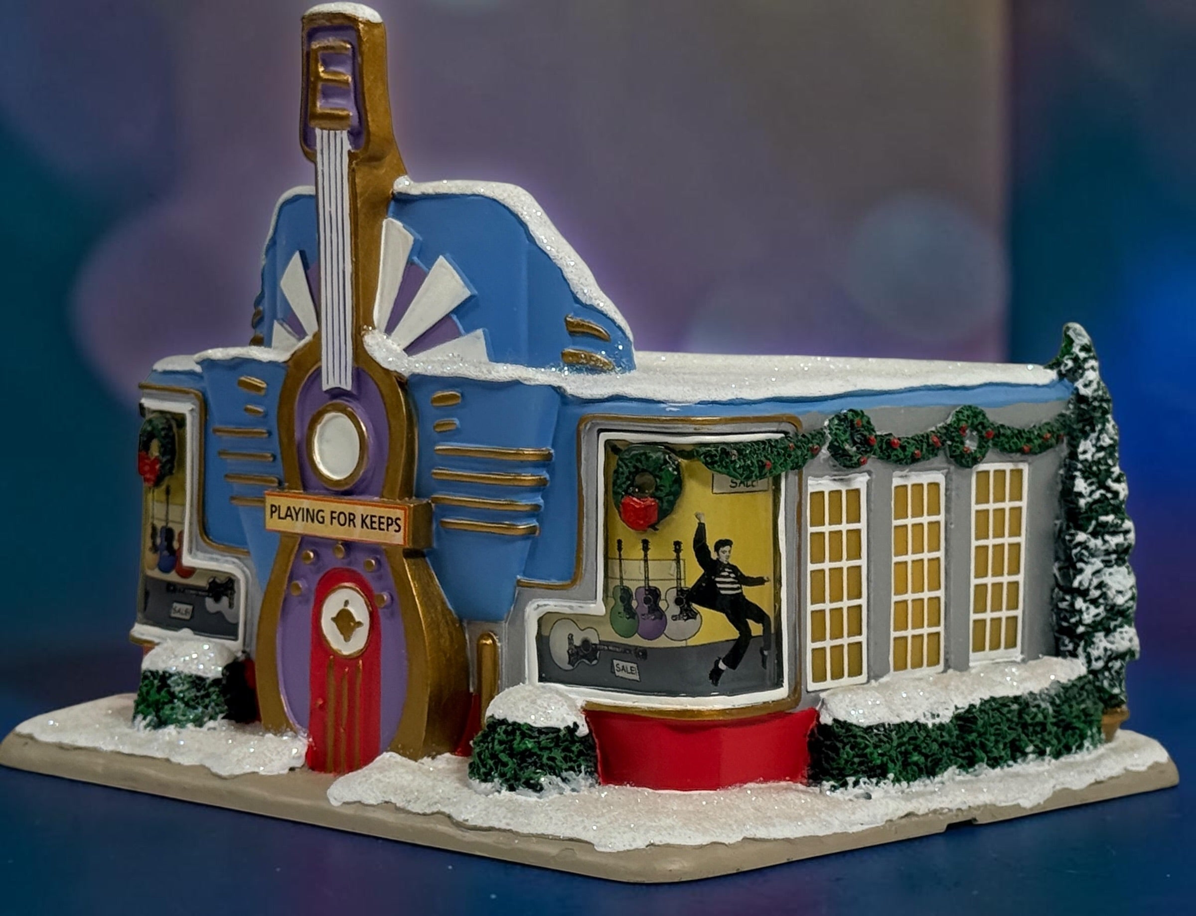 Official Hawthorne Village “Playing for Keeps” Guitar Store from the 2007 Elvis Presley Rock ‘n’ Roll Holiday Village collection featuring festive details and retro styling.