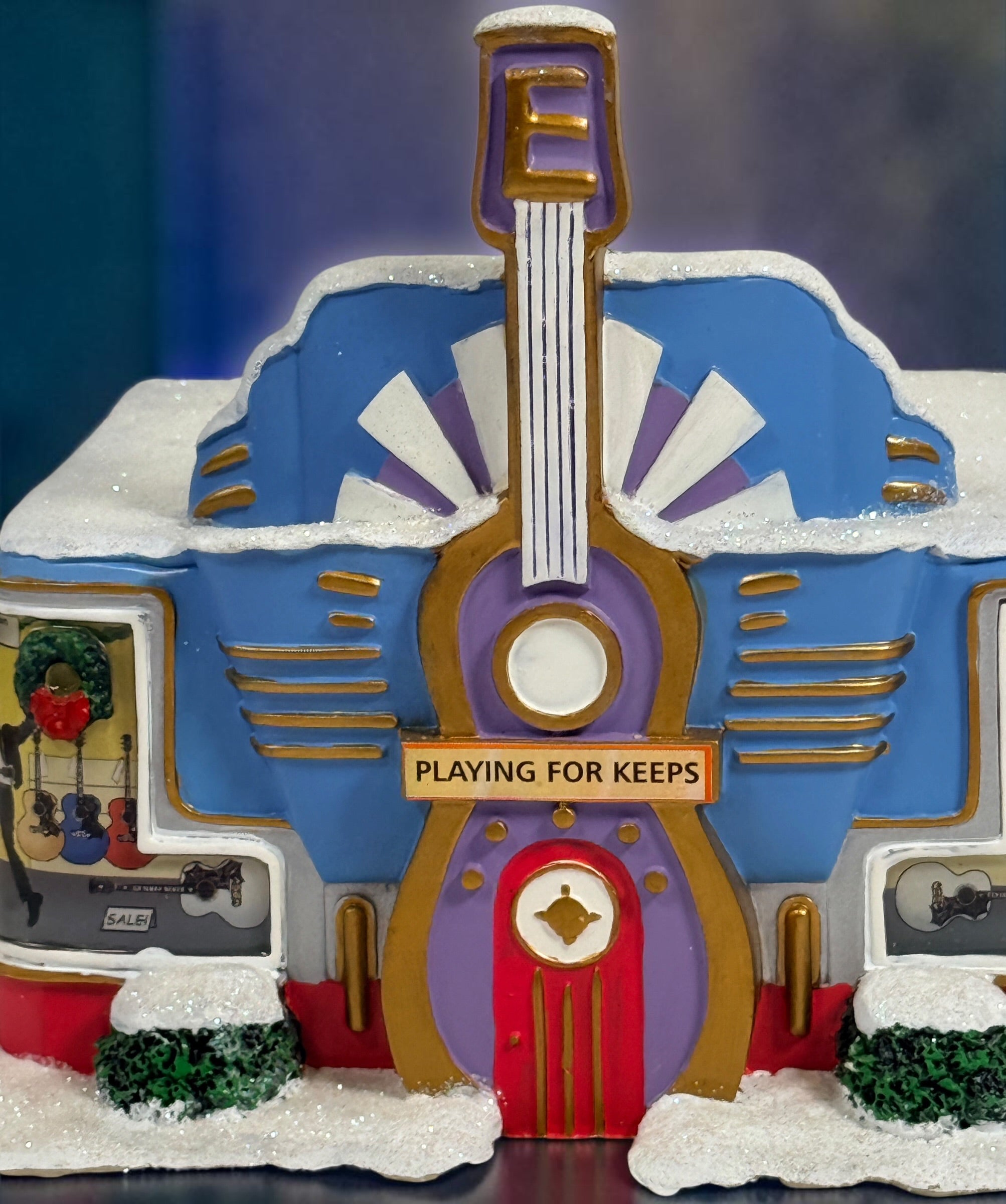 Official Hawthorne Village “Playing for Keeps” Guitar Store from the 2007 Elvis Presley Rock ‘n’ Roll Holiday Village collection featuring festive details and retro styling.