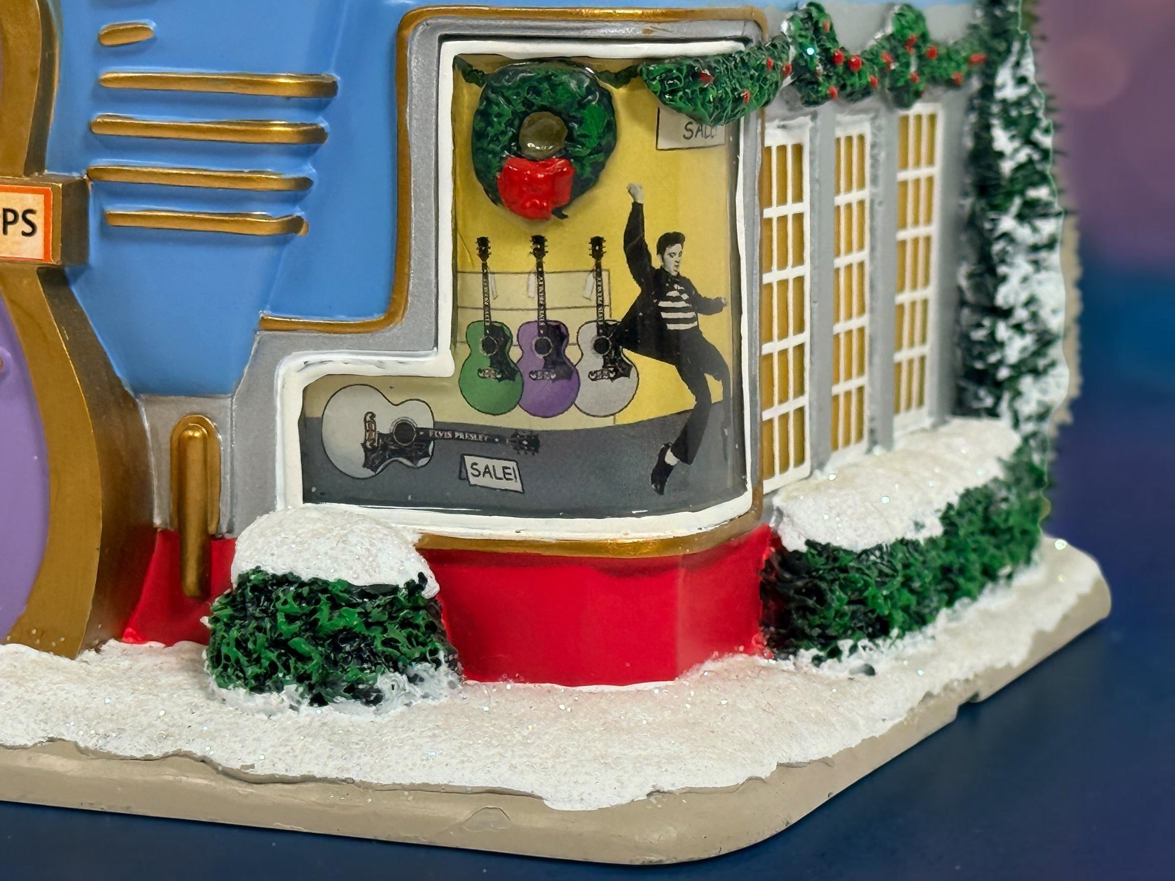 Official Hawthorne Village “Playing for Keeps” Guitar Store from the 2007 Elvis Presley Rock ‘n’ Roll Holiday Village collection featuring festive details and retro styling.