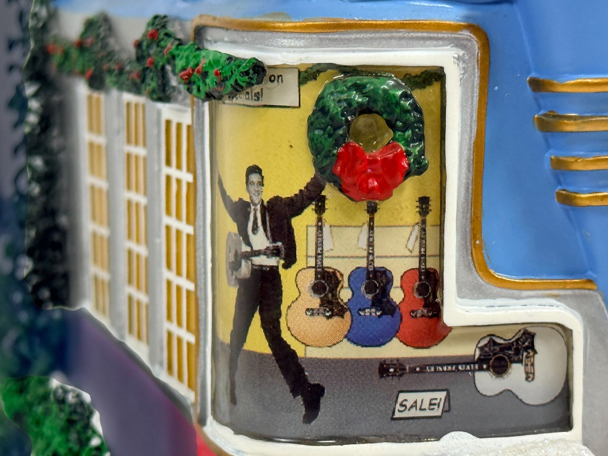 Official Hawthorne Village “Playing for Keeps” Guitar Store from the 2007 Elvis Presley Rock ‘n’ Roll Holiday Village collection featuring festive details and retro styling.
