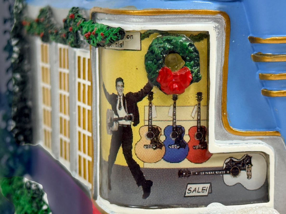 Official Hawthorne Village “Playing for Keeps” Guitar Store from the 2007 Elvis Presley Rock ‘n’ Roll Holiday Village collection featuring festive details and retro styling.