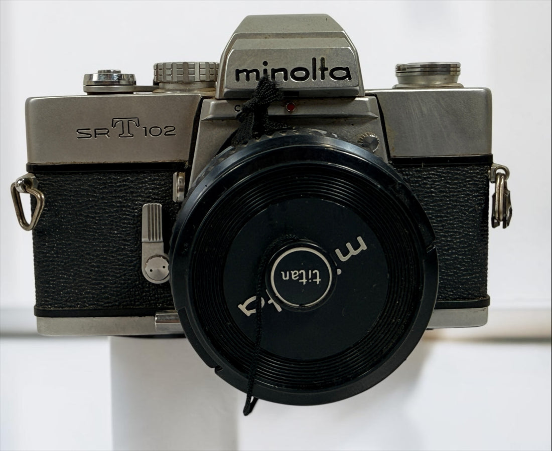 Vintage Minolta SRT 102 35 mm film camera with MC Rokkor-X 50 mm f/1.7 lens, made in Japan. Classic manual-focus SLR sold in untested condition.