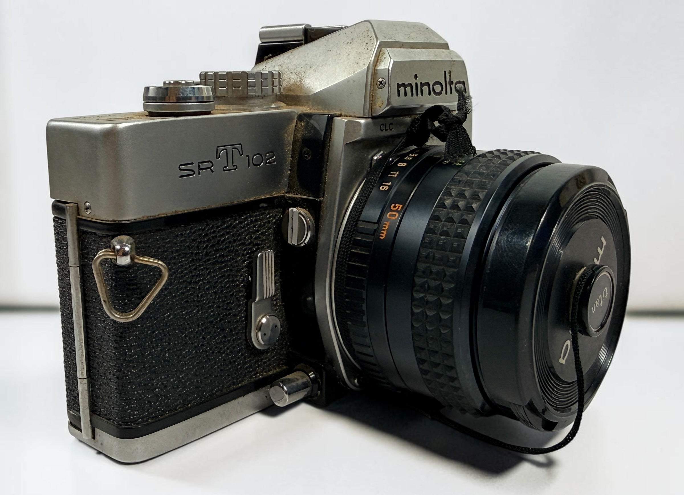 Vintage Minolta SRT 102 35 mm film camera with MC Rokkor-X 50 mm f/1.7 lens, made in Japan. Classic manual-focus SLR sold in untested condition.