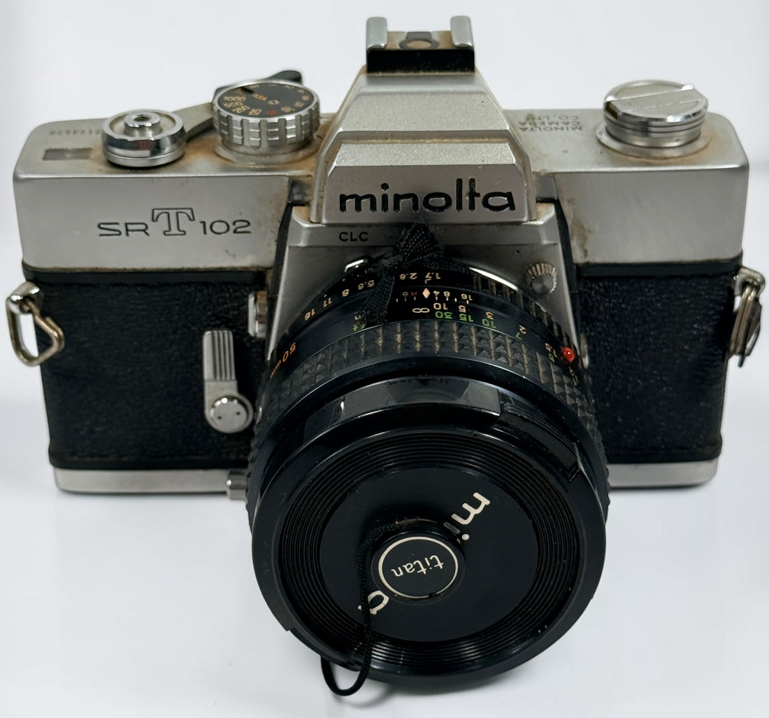 Vintage Minolta SRT 102 35 mm film camera with MC Rokkor-X 50 mm f/1.7 lens, made in Japan. Classic manual-focus SLR sold in untested condition.