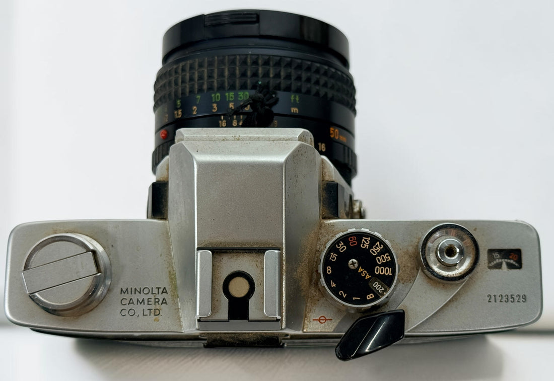 Vintage Minolta SRT 102 35 mm film camera with MC Rokkor-X 50 mm f/1.7 lens, made in Japan. Classic manual-focus SLR sold in untested condition.