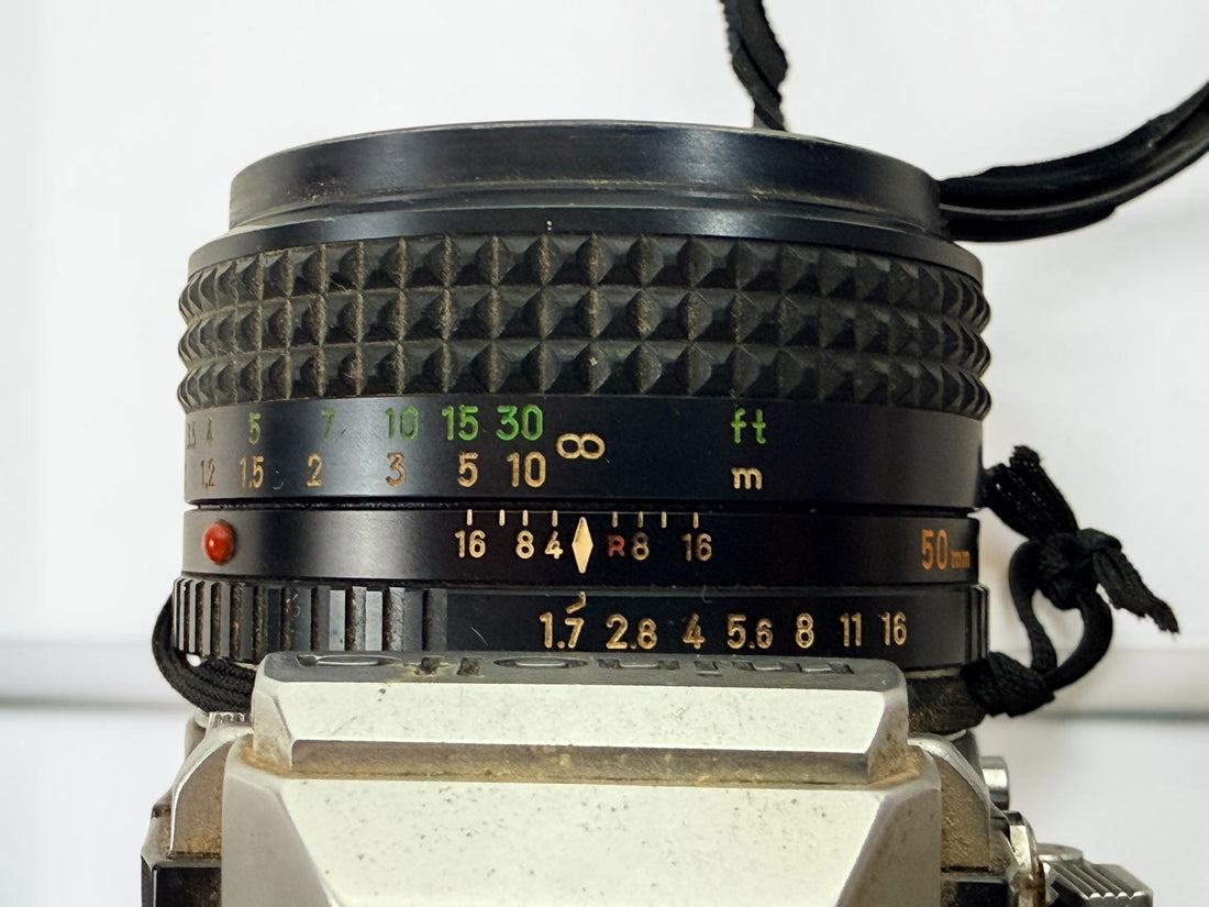 Vintage Minolta SRT 102 35 mm film camera with MC Rokkor-X 50 mm f/1.7 lens, made in Japan. Classic manual-focus SLR sold in untested condition.