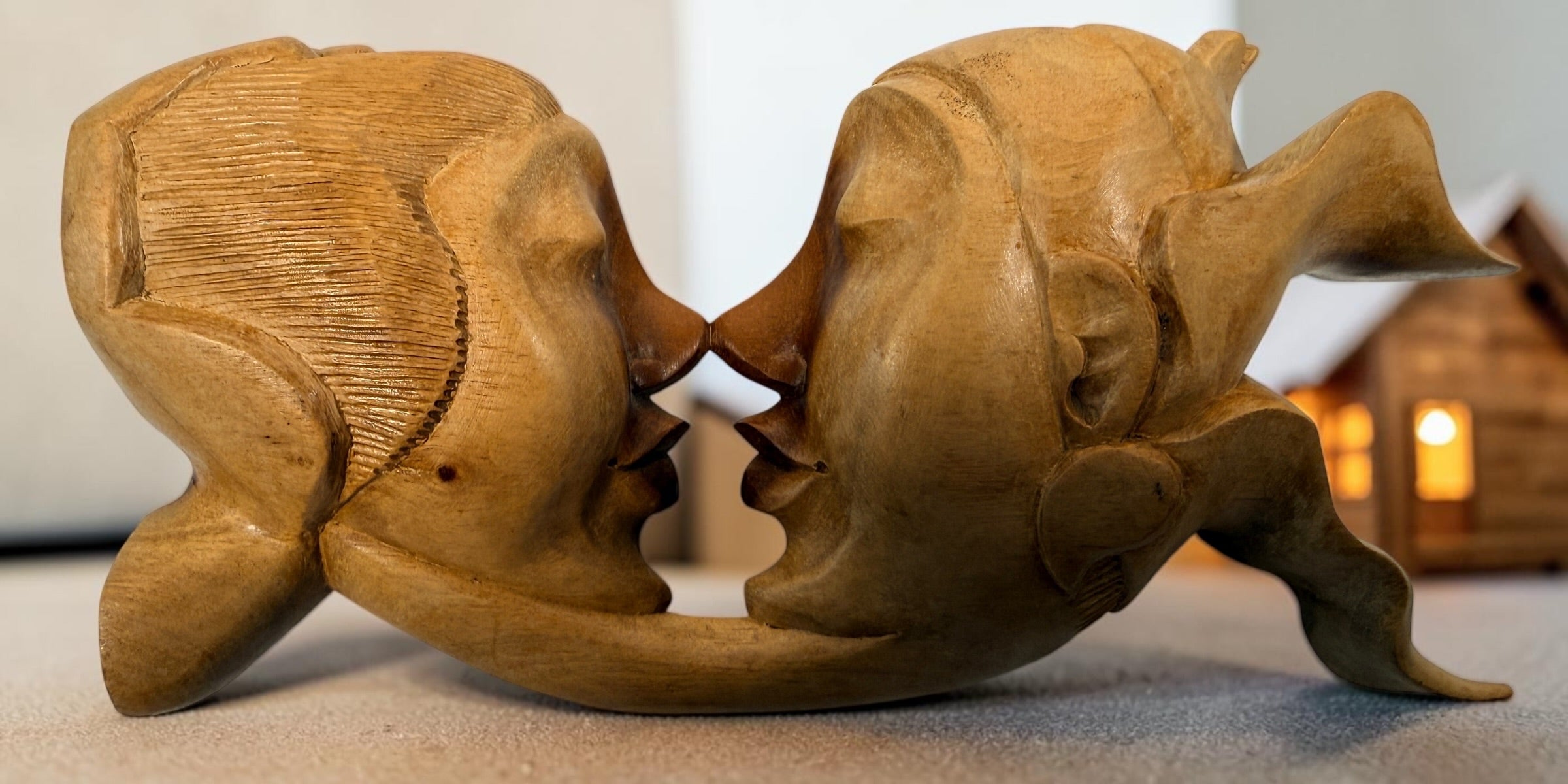 Vintage 8.5-inch Balinese kissing couple sculpture, hand carved in Indonesia from solid wood. Romantic Indonesian folk art with warm natural finish.