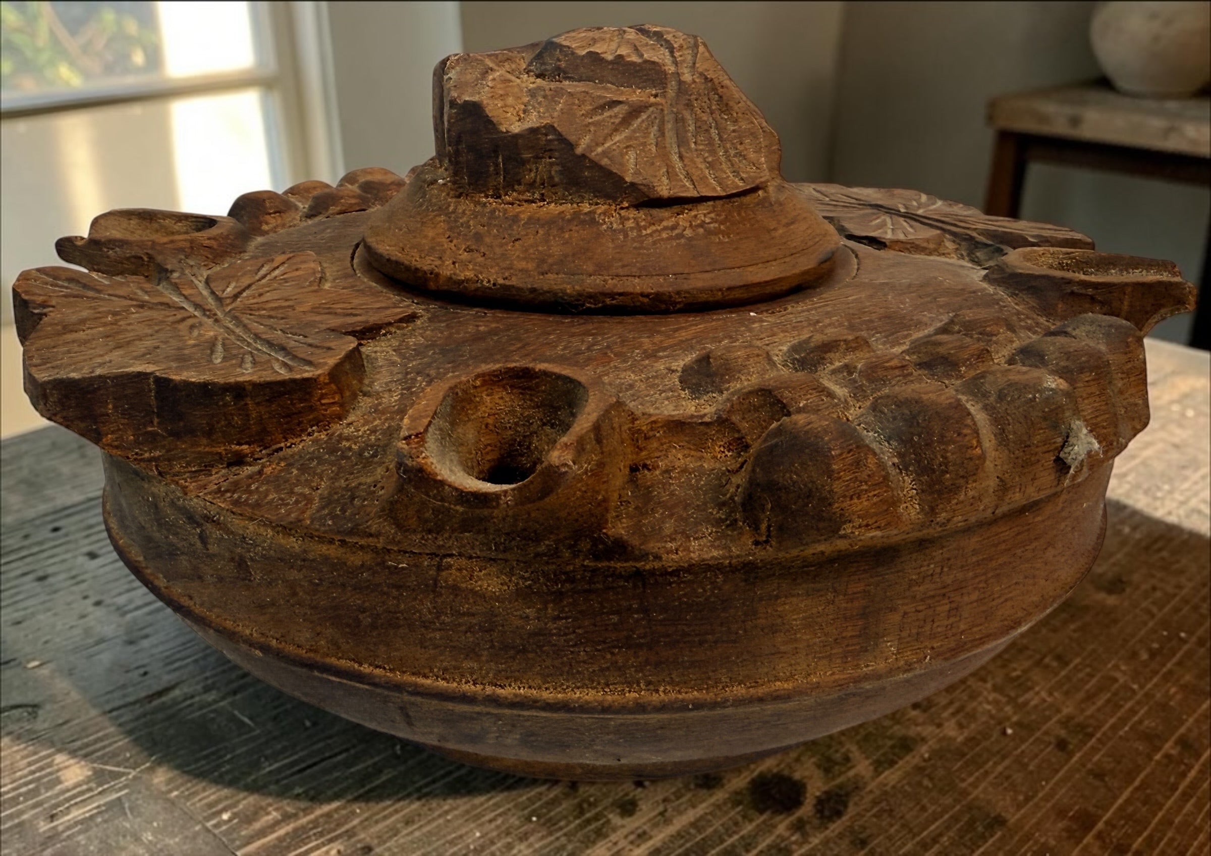 Vintage Savoyard wooden grolle with 4 drinking spouts, carved grapes and vine leaves. Traditional French Alpine communal coffee vessel and folk art.