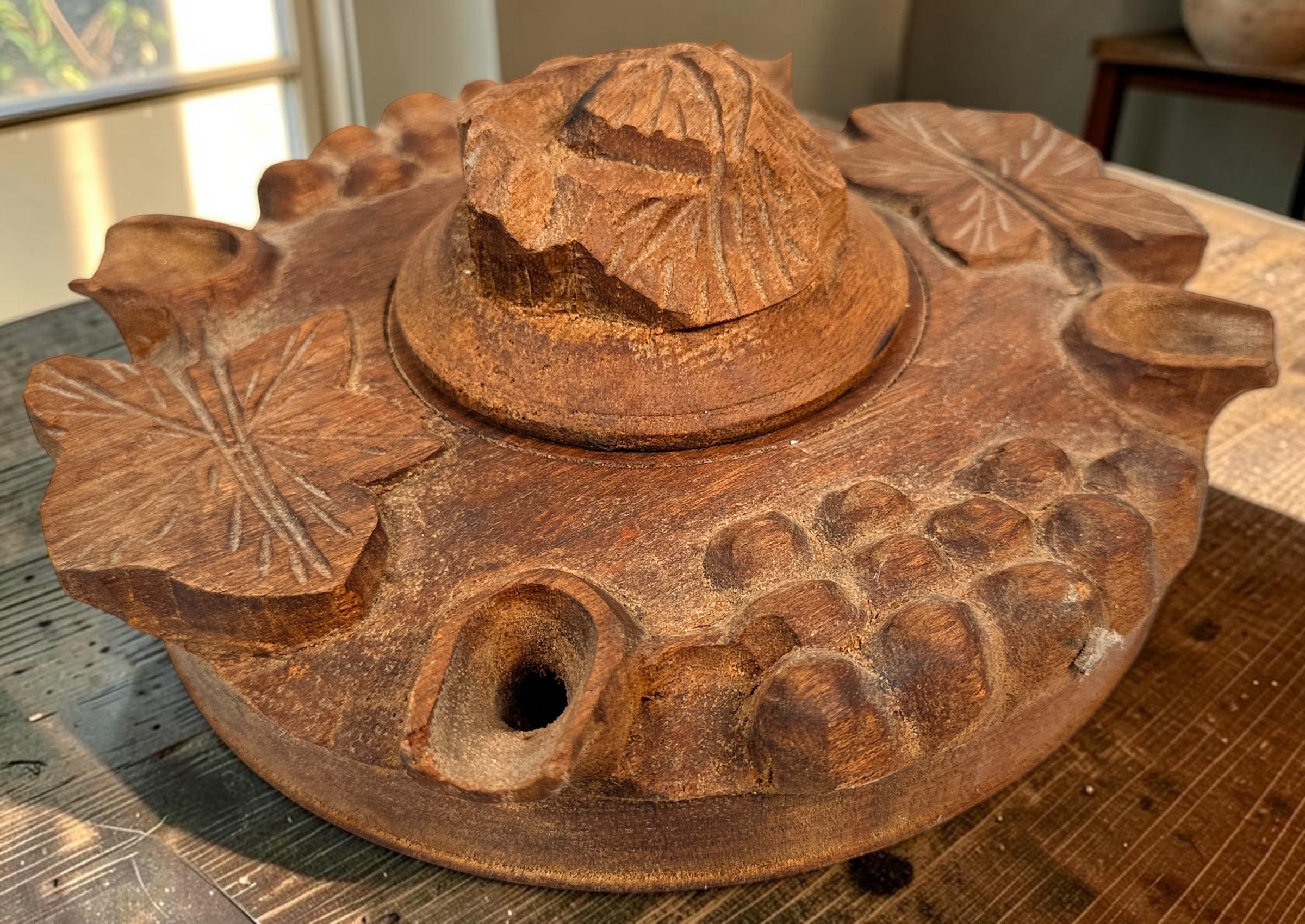 Vintage Savoyard wooden grolle with 4 drinking spouts, carved grapes and vine leaves. Traditional French Alpine communal coffee vessel and folk art.