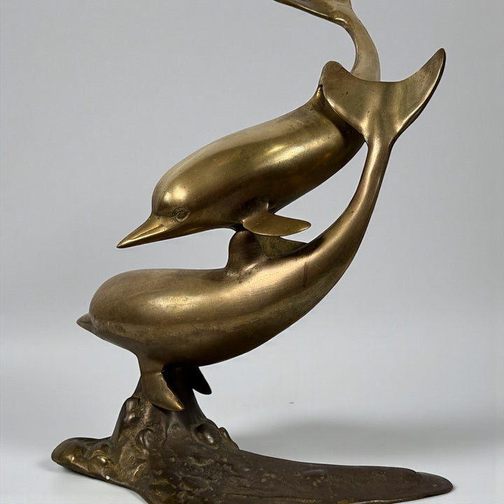 Vintage mid-century brass dolphin sculpture, 13.5 inches tall. Solid cast brass with natural patina, coastal Hollywood Regency decor.