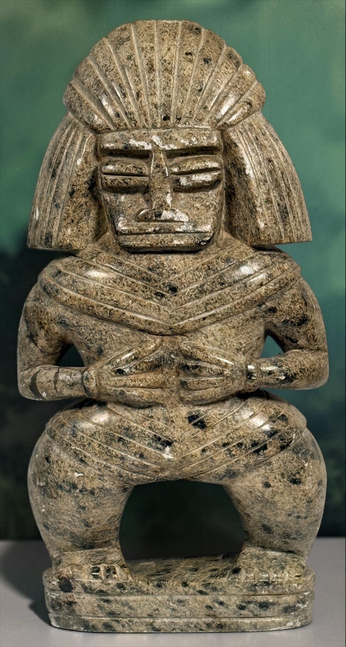 Hand-carved stone warrior figure in Pre-Columbian Mesoamerican style with detailed headdress and geometric features. Unique vintage decorative sculpture.