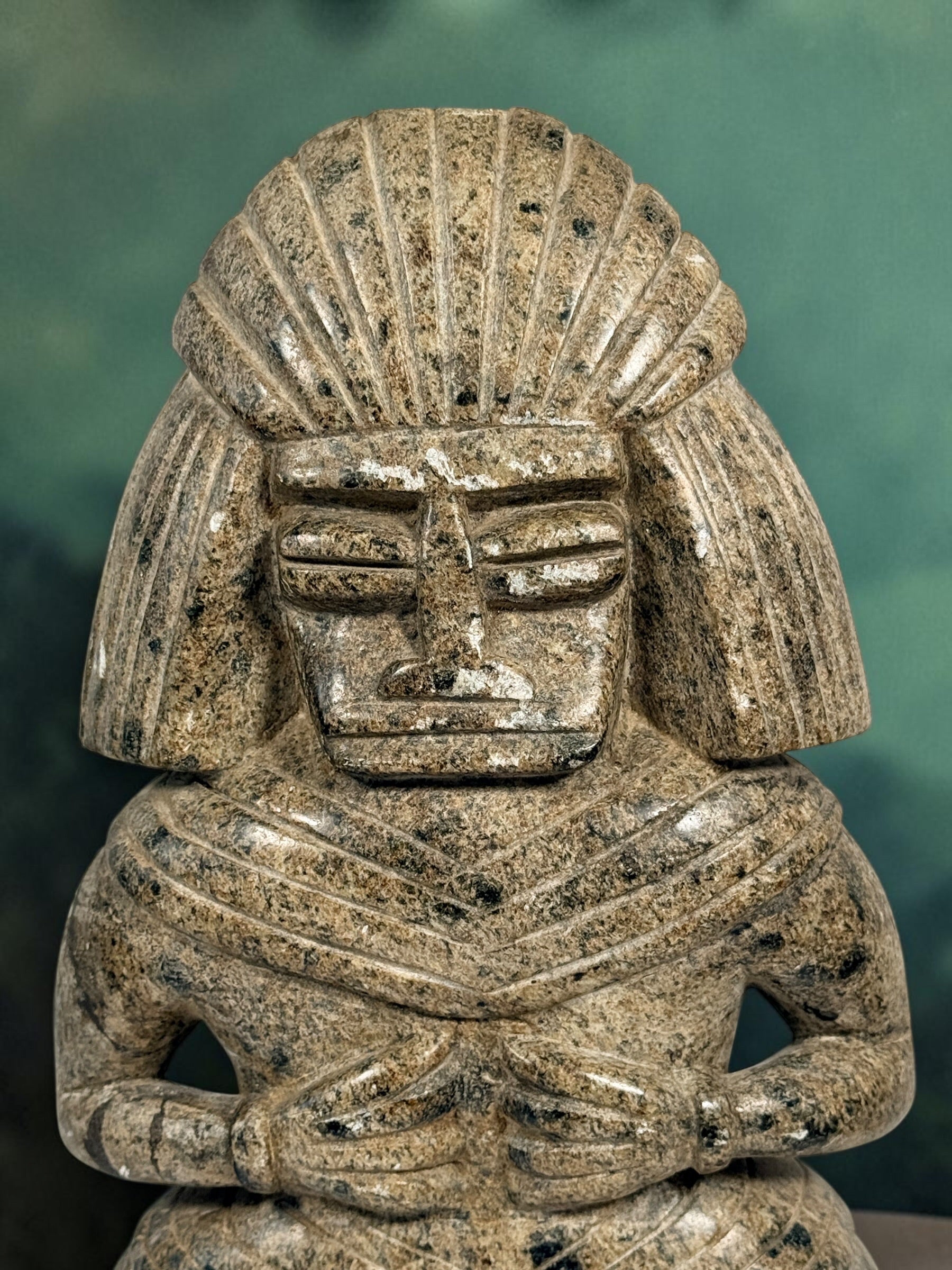Hand-carved stone warrior figure in Pre-Columbian Mesoamerican style with detailed headdress and geometric features. Unique vintage decorative sculpture.