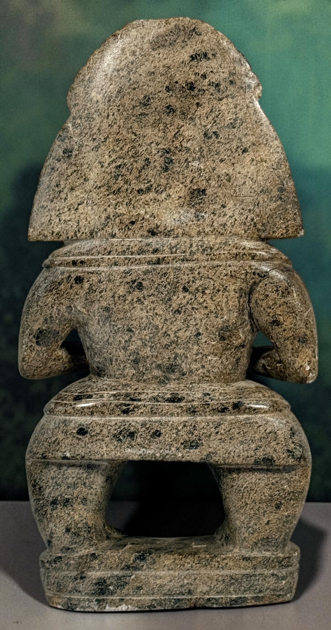 Hand-carved stone warrior figure in Pre-Columbian Mesoamerican style with detailed headdress and geometric features. Unique vintage decorative sculpture.