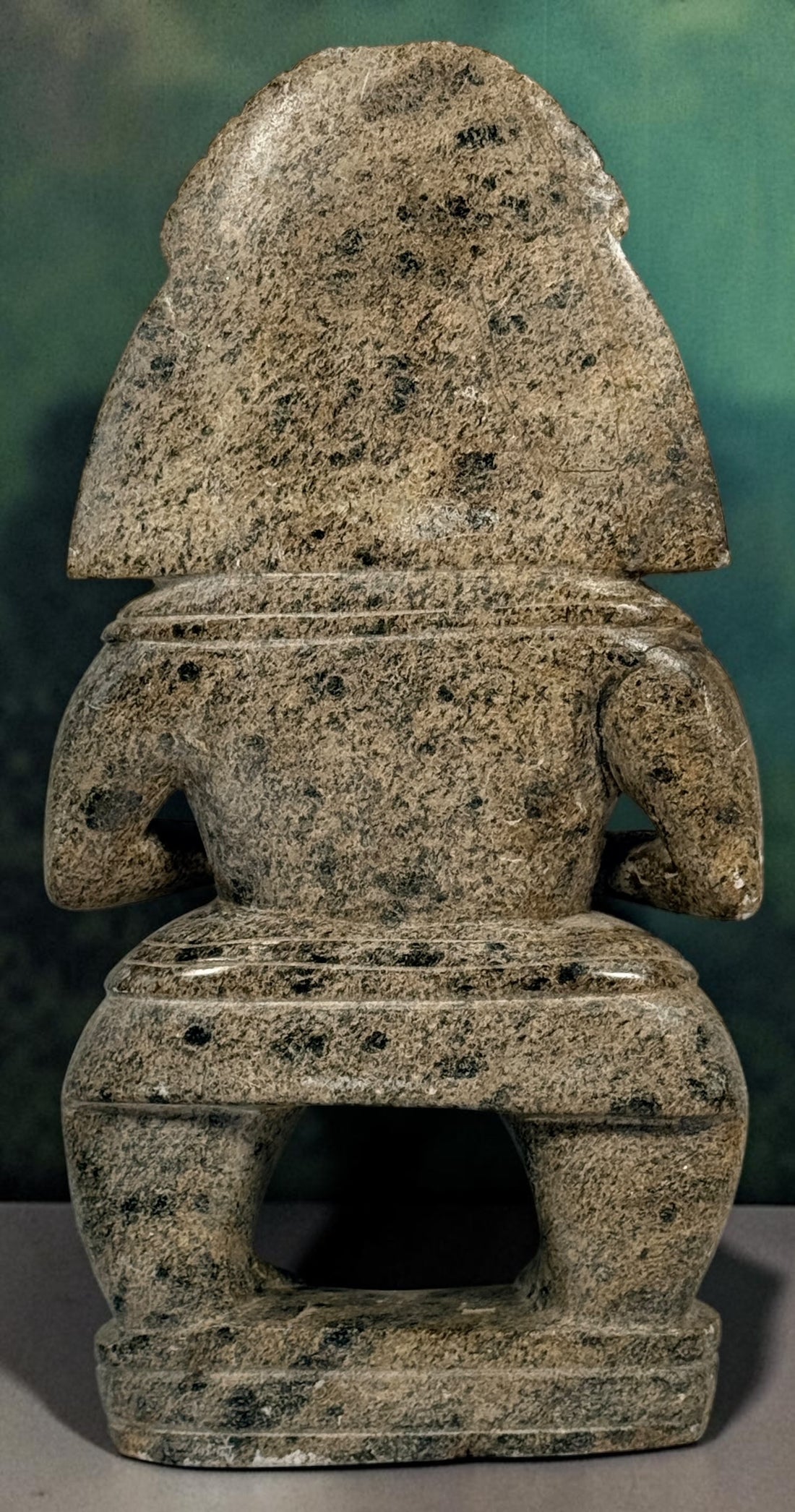 Hand-carved stone warrior figure in Pre-Columbian Mesoamerican style with detailed headdress and geometric features. Unique vintage decorative sculpture.