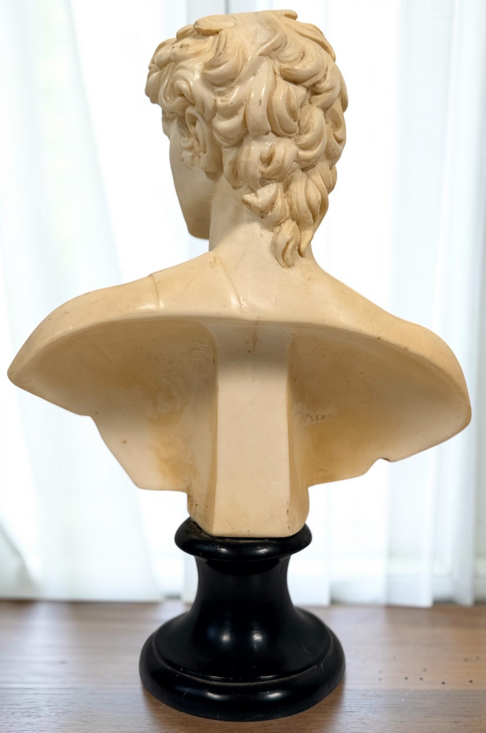 Vintage A. Santini Michelangelo David bust, made in Italy with faux-alabaster finish and black pedestal base. Classic Italian decorative sculpture.
