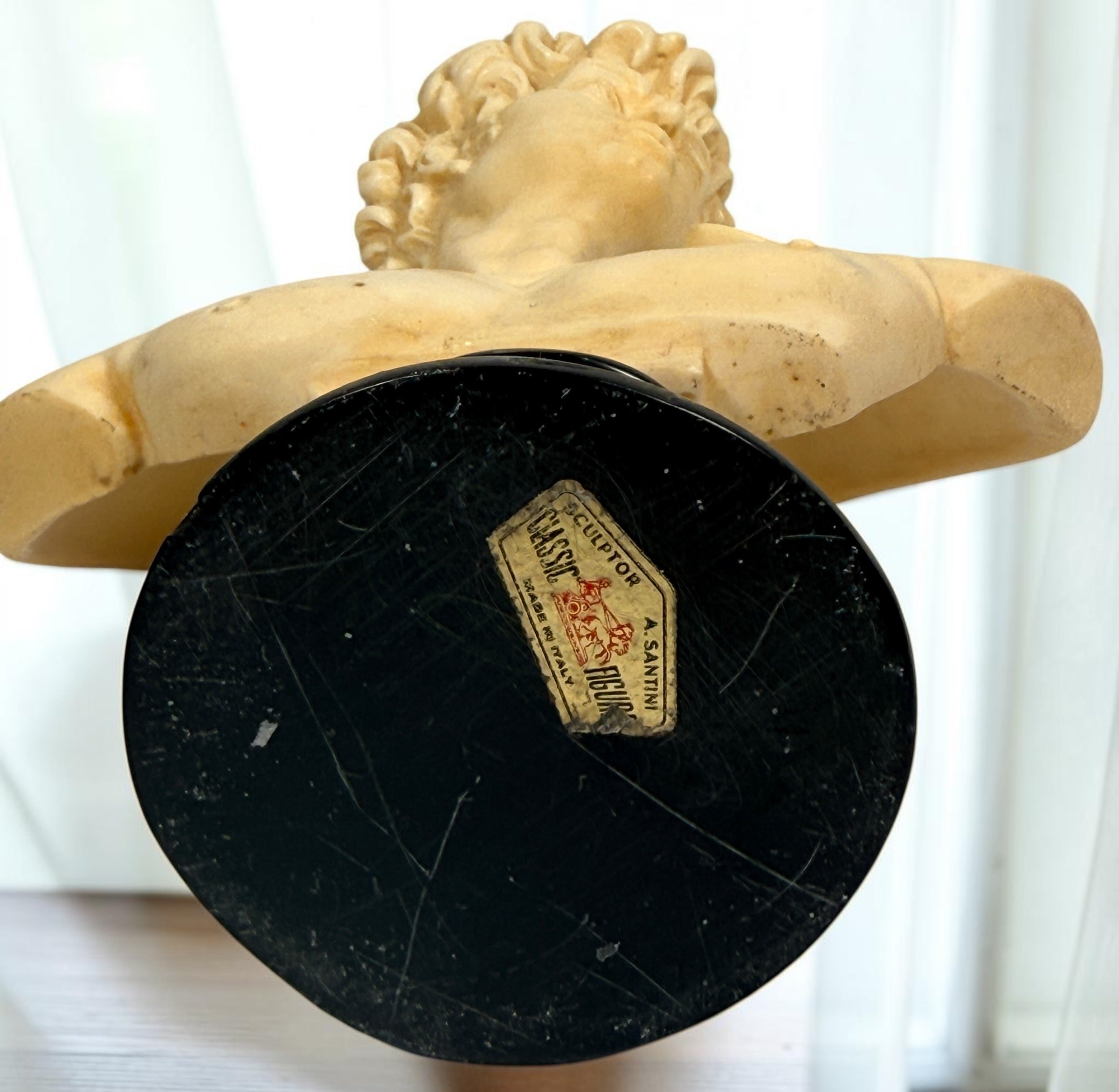 Vintage A. Santini Michelangelo David bust, made in Italy with faux-alabaster finish and black pedestal base. Classic Italian decorative sculpture.