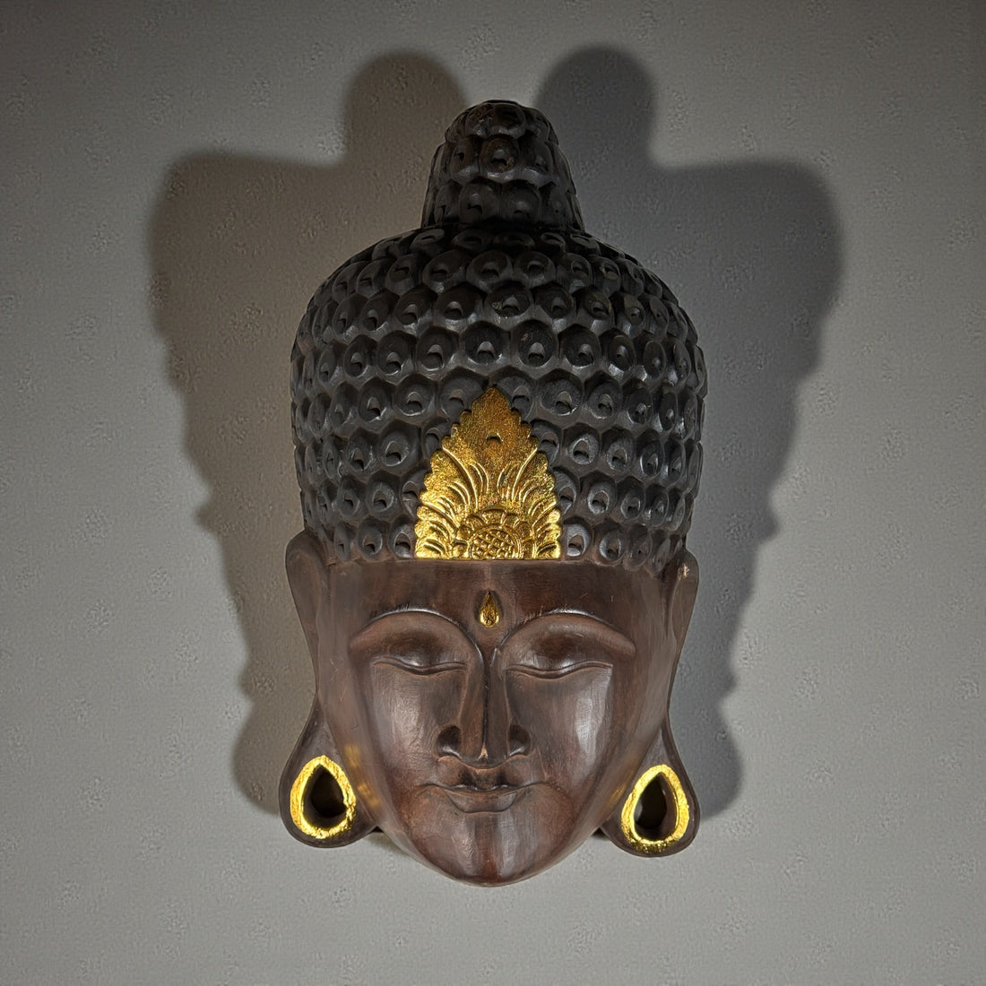 Large hand-carved wooden Buddha wall mask with gold accents, 20 inches tall. Southeast Asian decorative carving, hollow-back wall mount.