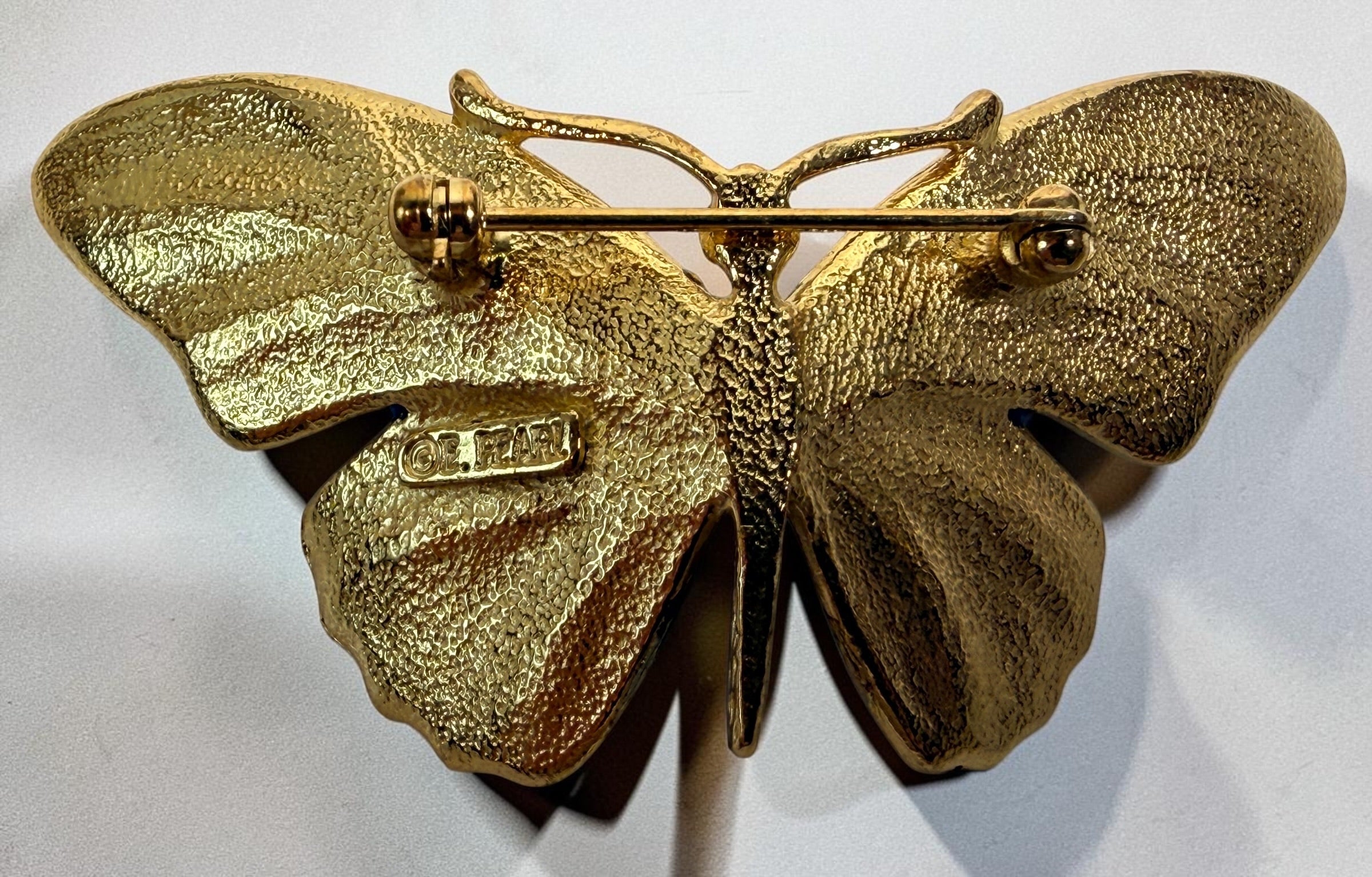 Vintage Erwin Pearl butterfly brooch with emerald and blue enamel wings, gold-tone finish and crystal eyes. Signed E. Pearl vintage costume jewelry.