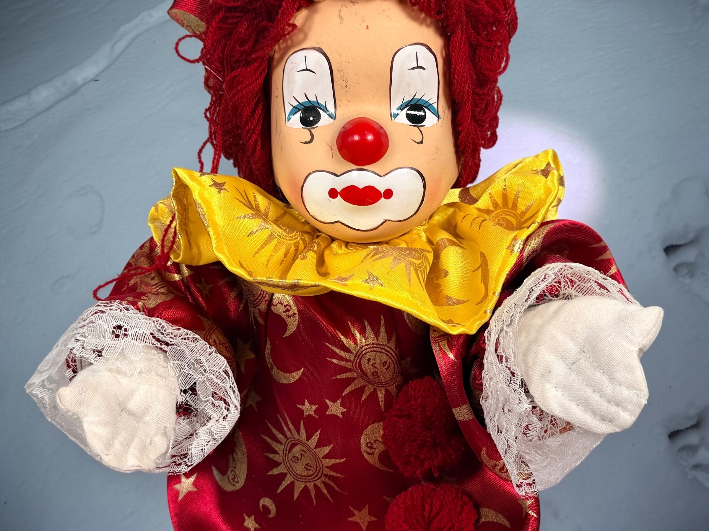 SEO Meta Description: Vintage 12-inch Pierrot clown doll with red and gold celestial costume, yarn hair and painted face. Distinctive collectible circus décor.