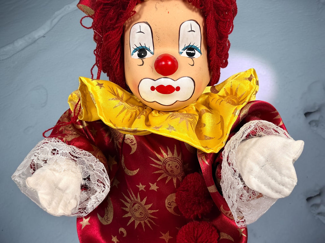 SEO Meta Description: Vintage 12-inch Pierrot clown doll with red and gold celestial costume, yarn hair and painted face. Distinctive collectible circus décor.