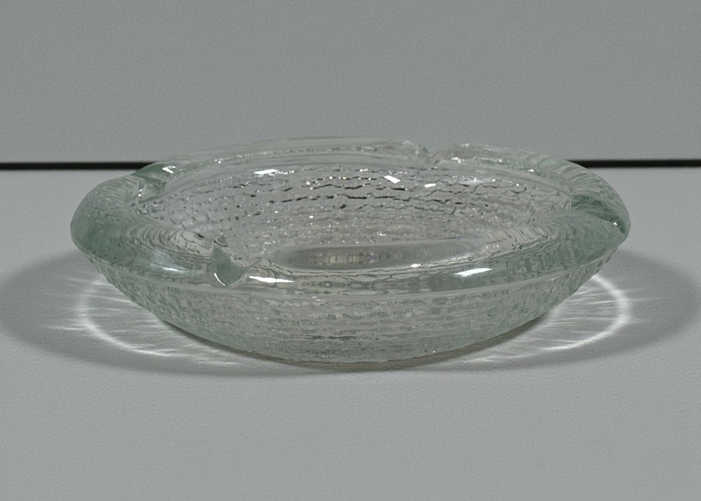 Vintage Iittala Ultima Thule glass ashtray by Tapio Wirkkala, 8 inch diameter. Iconic Finnish modernist pressed glass design.