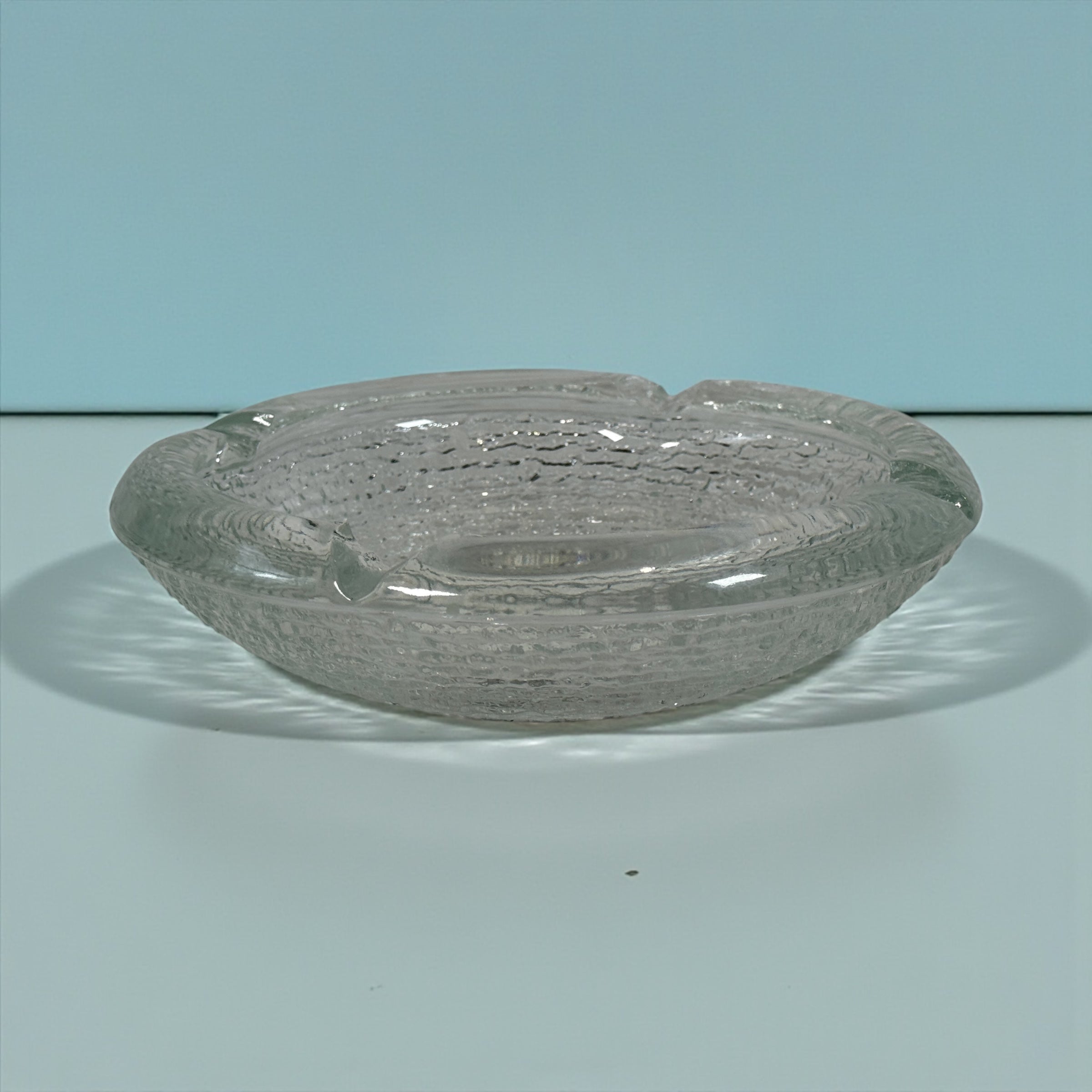 Vintage Iittala Ultima Thule glass ashtray by Tapio Wirkkala, 8 inch diameter. Iconic Finnish modernist pressed glass design.