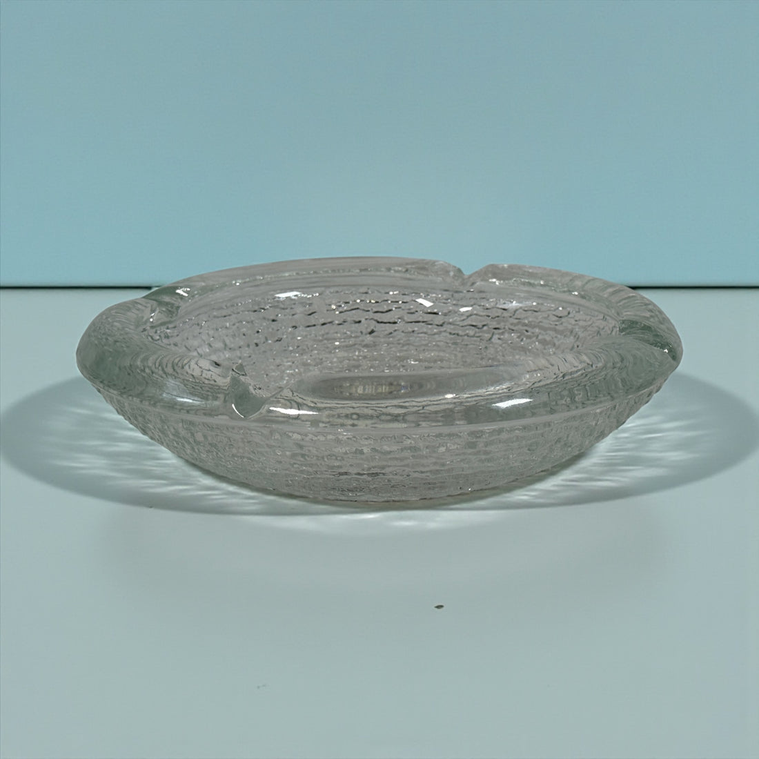 Vintage Iittala Ultima Thule glass ashtray by Tapio Wirkkala, 8 inch diameter. Iconic Finnish modernist pressed glass design.