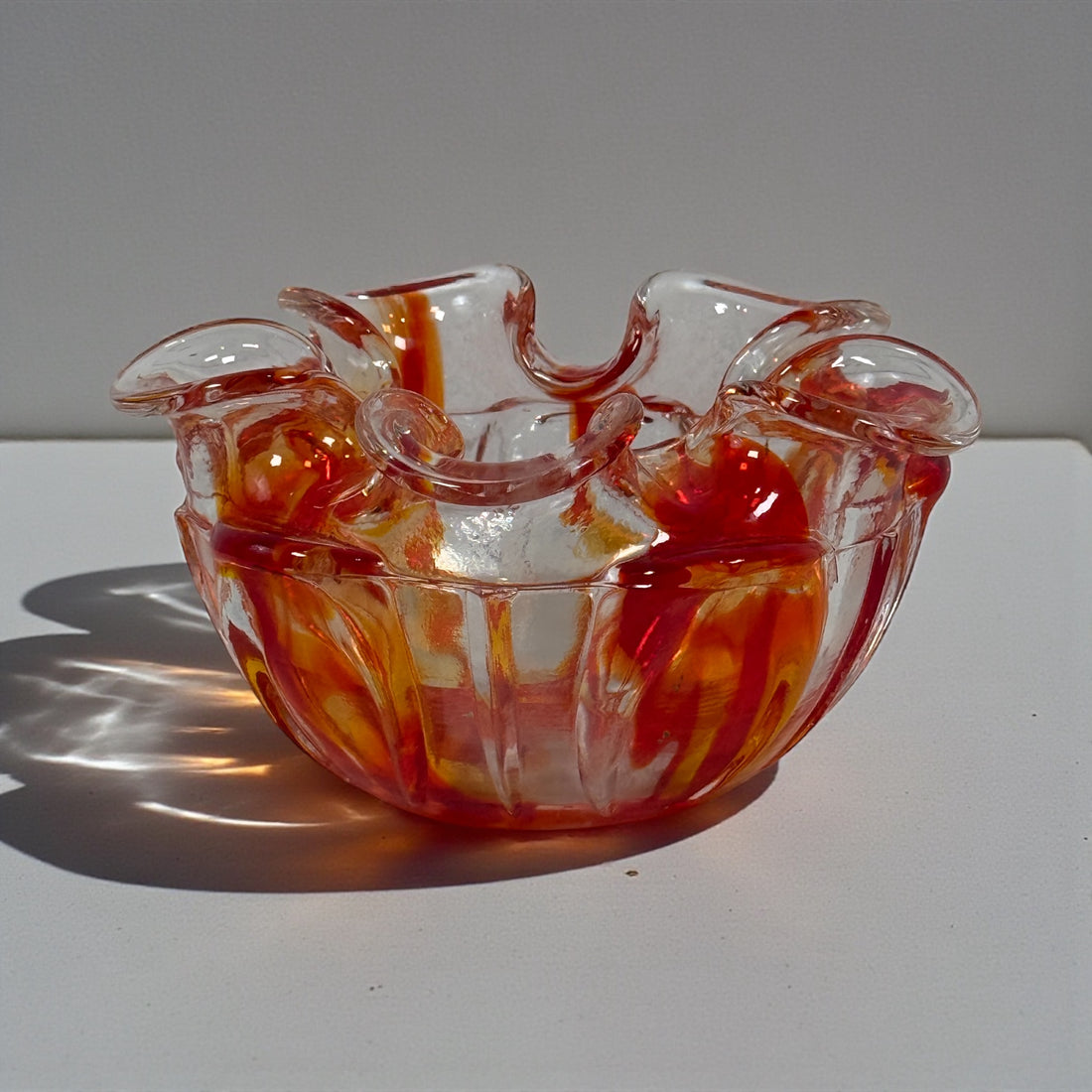 Vintage Murano-style Italian sommerso art glass bowl with red and amber encased glass and folded rim. Hand-blown decorative bowl, 6 inches wide.