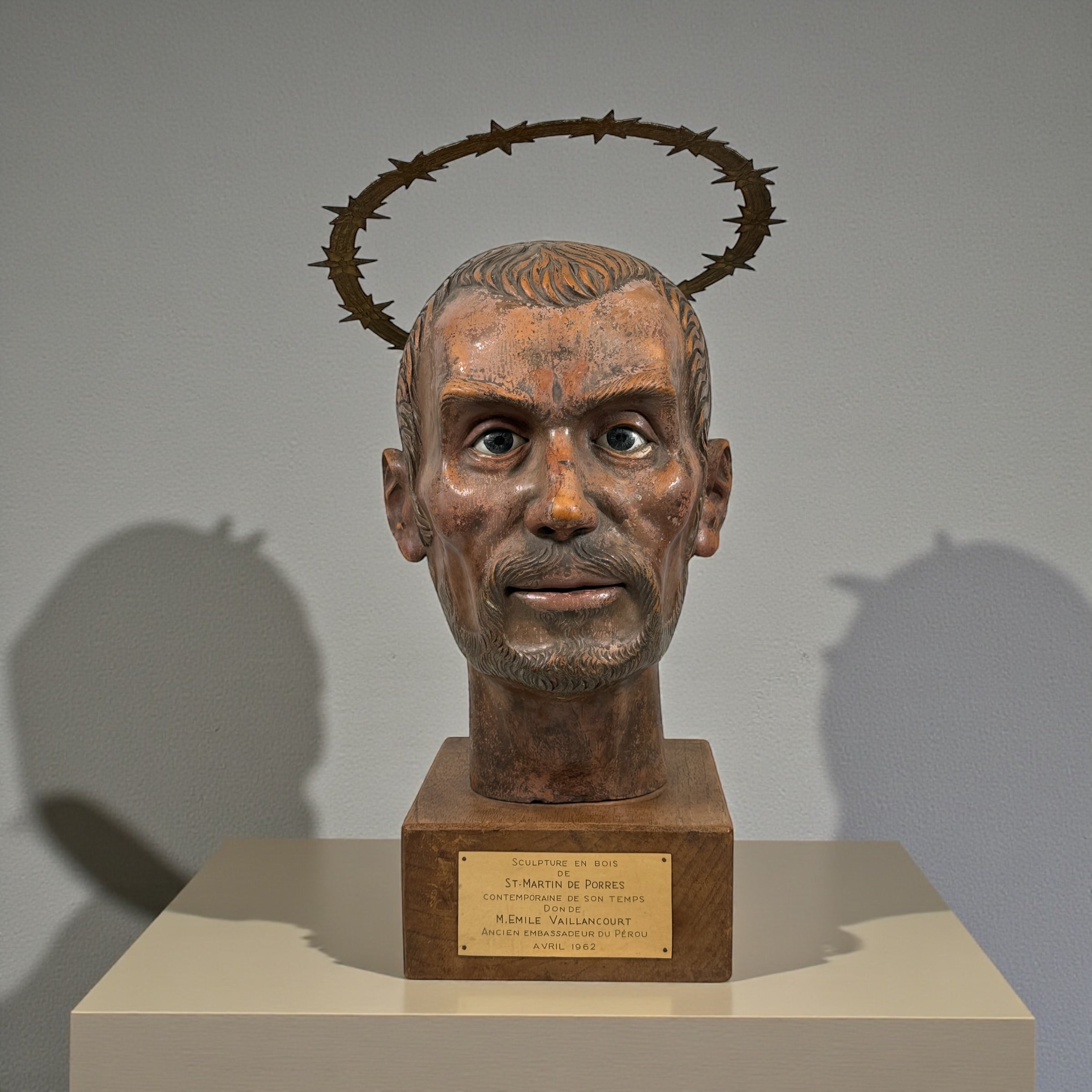 Wood bust of Saint Martin de Porres (1962) with diplomatic provenance from Canadian Ambassador in Peru. Glass eyes, halo, presentation plaque. Rare devotional art.