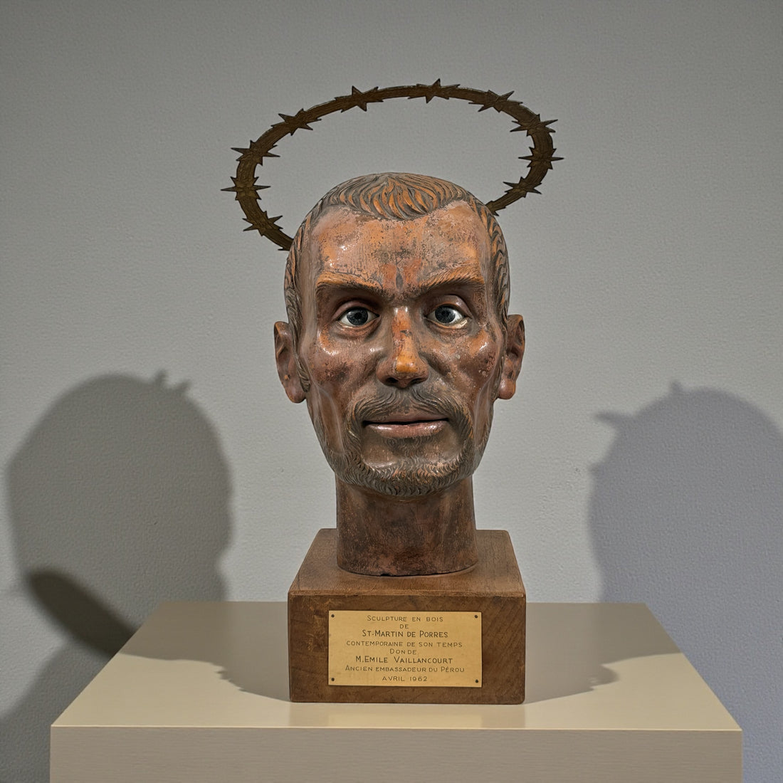 Wood bust of Saint Martin de Porres (1962) with diplomatic provenance from Canadian Ambassador in Peru. Glass eyes, halo, presentation plaque. Rare devotional art.