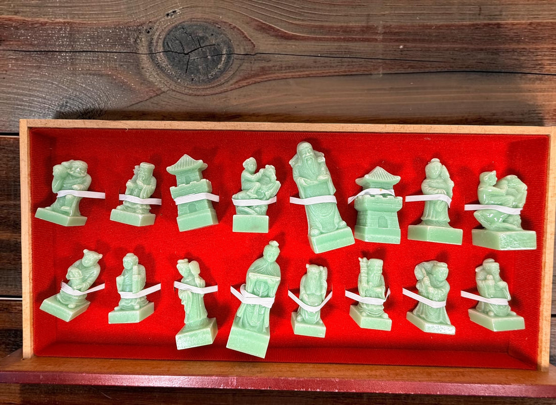 Vintage Chinese 32-piece figural chess set with jade-coloured pieces, carved dragon folding wood board, illustrated squares and fitted storage.
