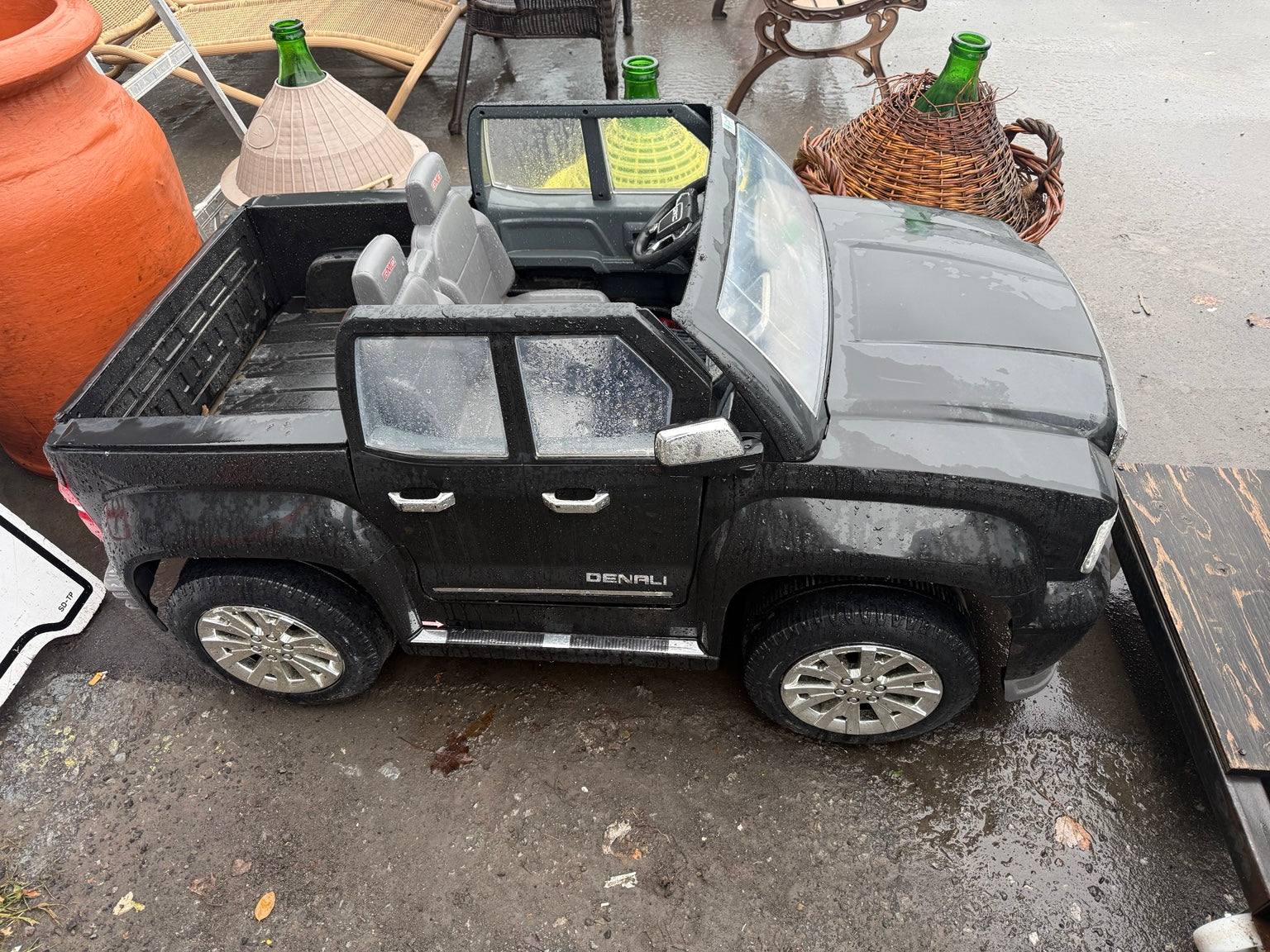 Opposite side of used GMC Denali ride-on toy truck with visible wear