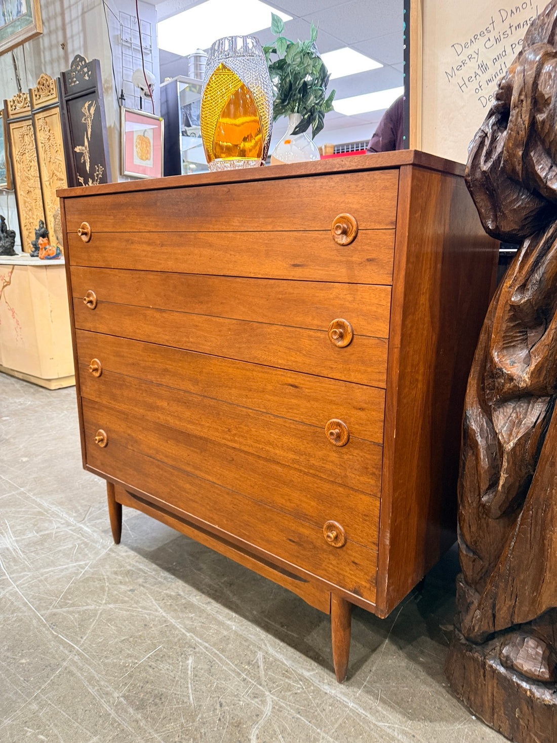Vintage four-drawer dresser three-quarter view showing tapered legs