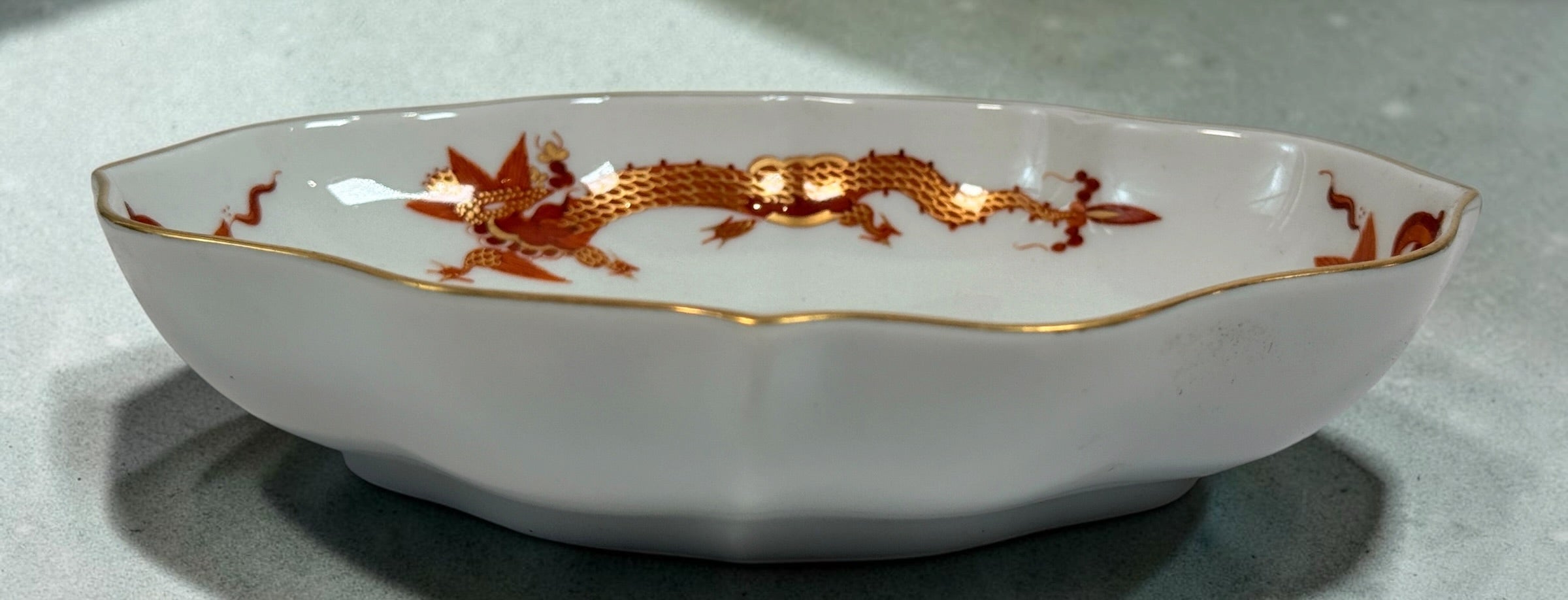 Vintage Meissen Red Dragon oval porcelain dish with gold trim and scalloped edges. Measures 6 × 4.5 inches. Collectible German porcelain.
