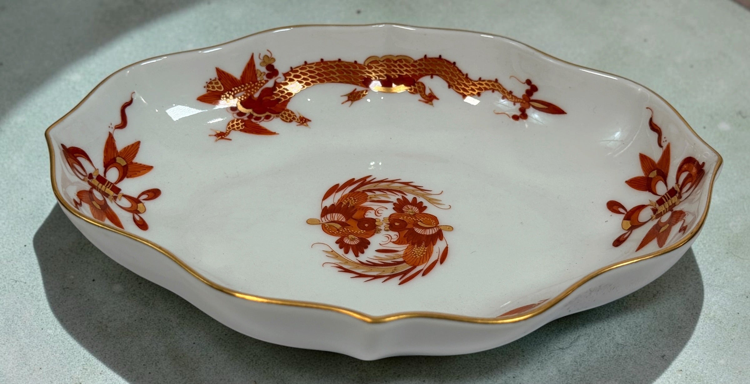 Vintage Meissen Red Dragon oval porcelain dish with gold trim and scalloped edges. Measures 6 × 4.5 inches. Collectible German porcelain.