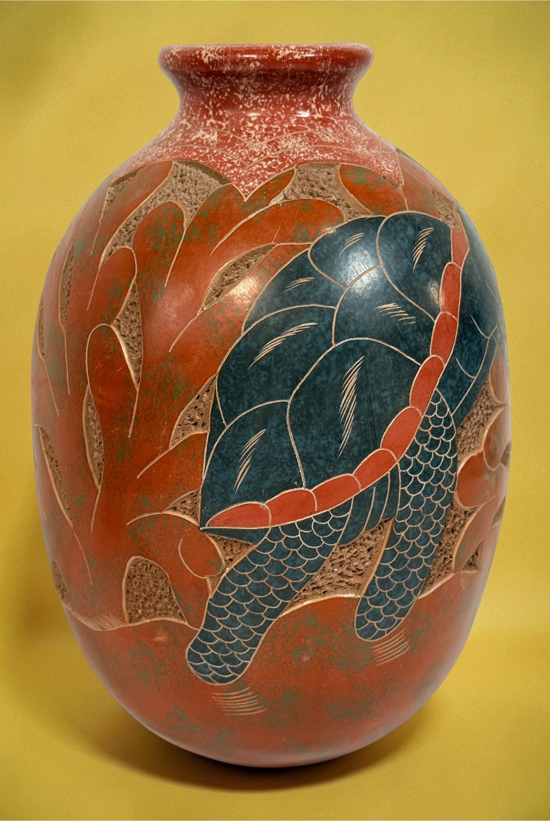 Decorative signed Latin American pottery vase featuring a carved sea turtle, terracotta finish and intricate sgraffito-style detailing.
