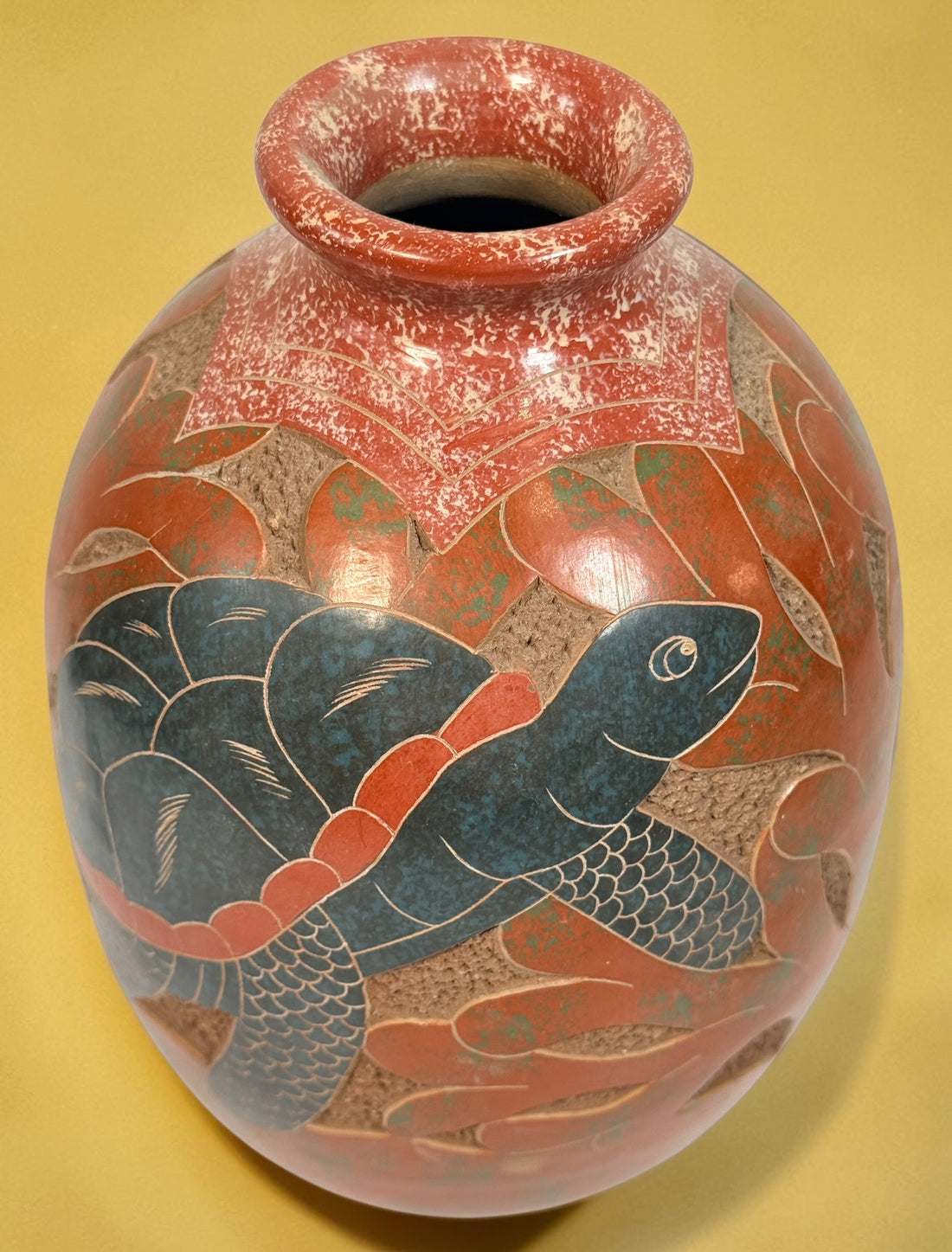 Decorative signed Latin American pottery vase featuring a carved sea turtle, terracotta finish and intricate sgraffito-style detailing.