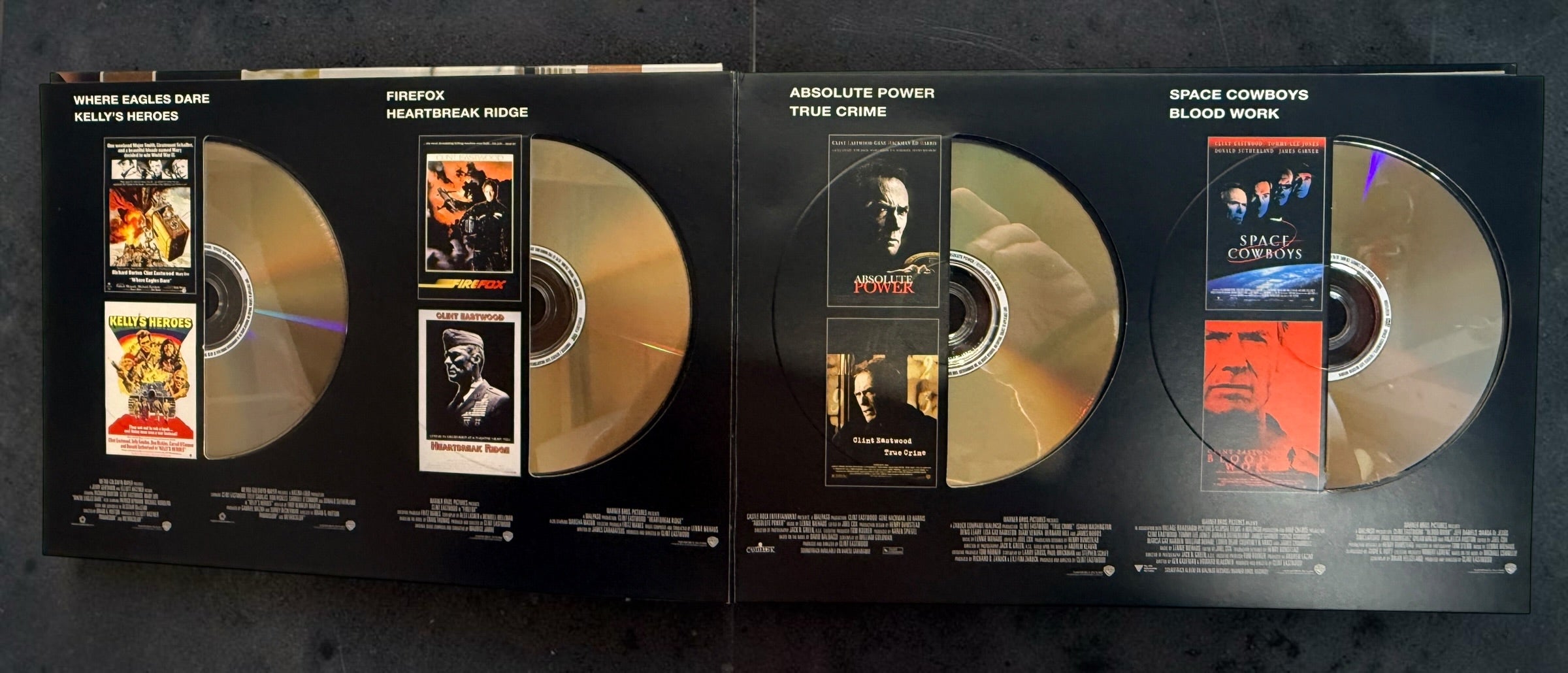 Clint Eastwood 40-Film Collection on 24 DVDs with illustrated collector's case and hardcover companion book. Pre-owned Warner Bros. movie box set.