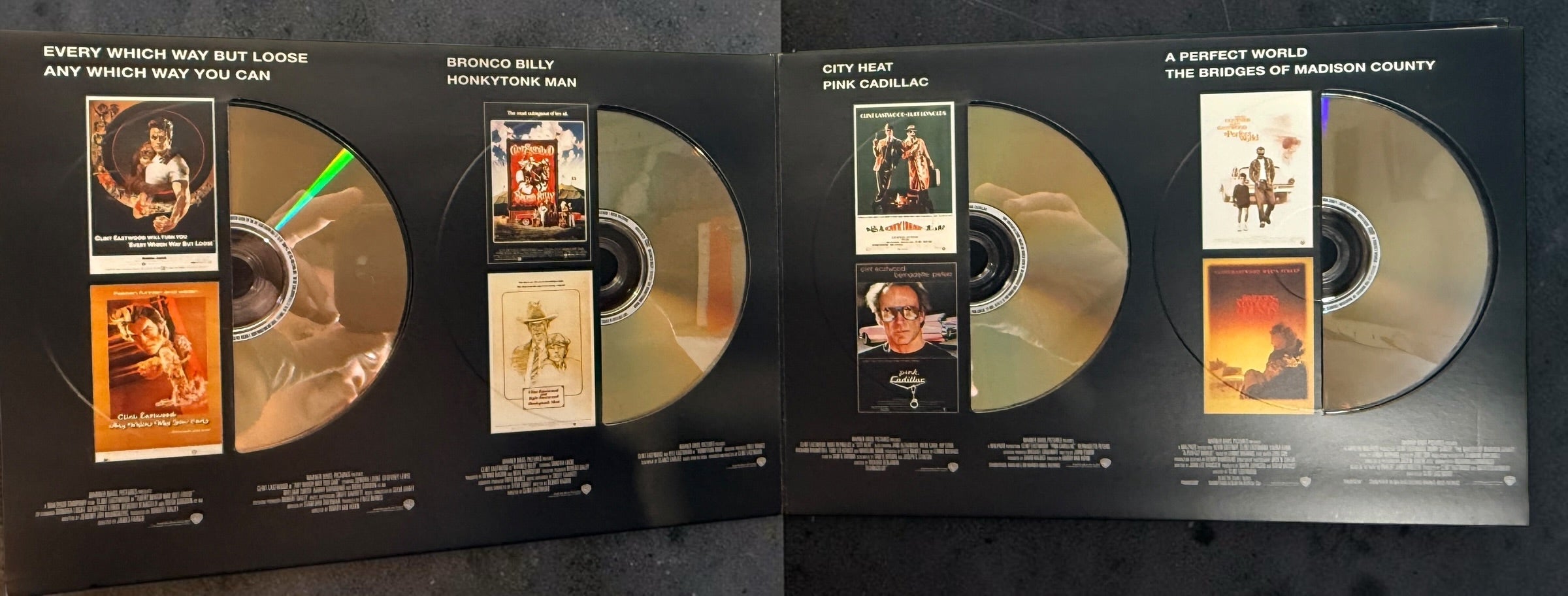 Clint Eastwood 40-Film Collection on 24 DVDs with illustrated collector's case and hardcover companion book. Pre-owned Warner Bros. movie box set.