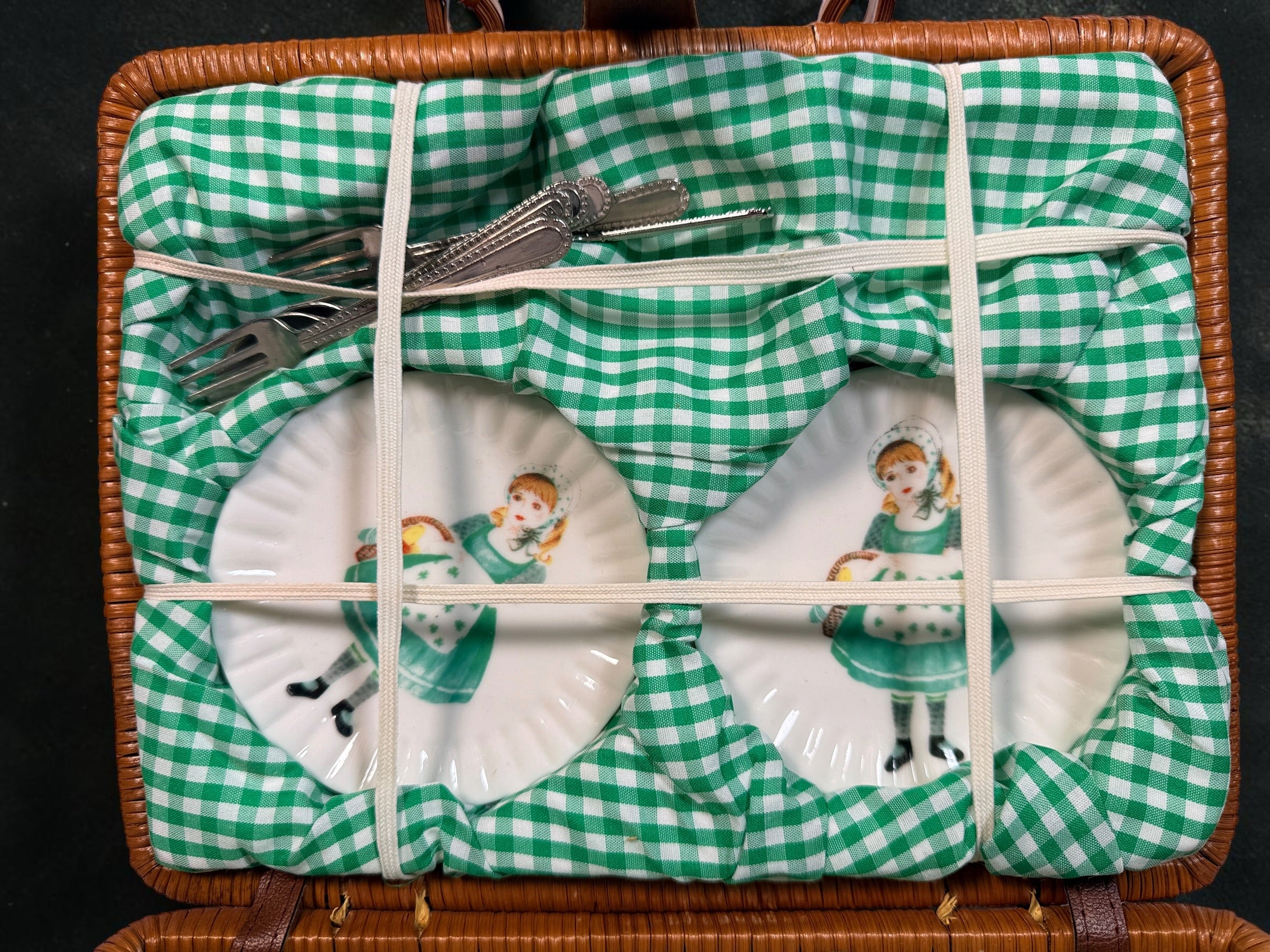 Vintage Delton miniature ceramic tea set with Irish girl and shamrock designs, complete with green gingham-lined wicker picnic basket.