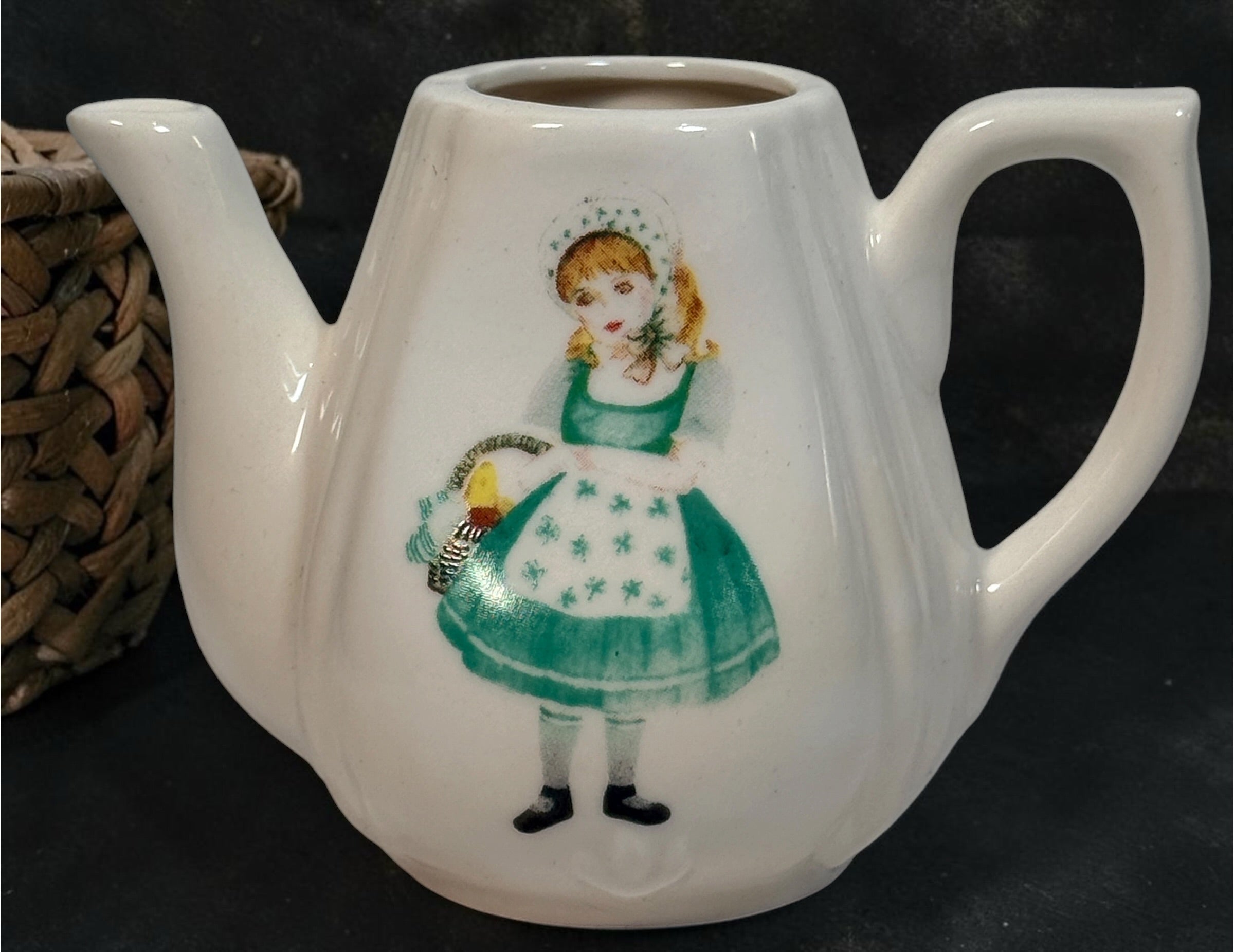 Vintage Delton miniature ceramic tea set with Irish girl and shamrock designs, complete with green gingham-lined wicker picnic basket.